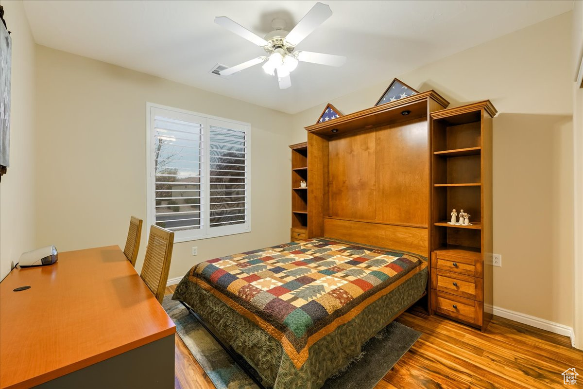 Bedroom featuring hardwood / wood-style flooring and ceiling fan