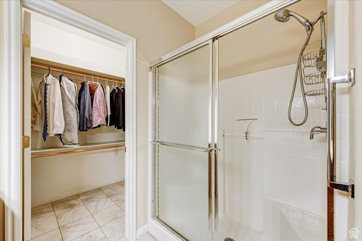 Bathroom with tile patterned flooring and an enclosed shower