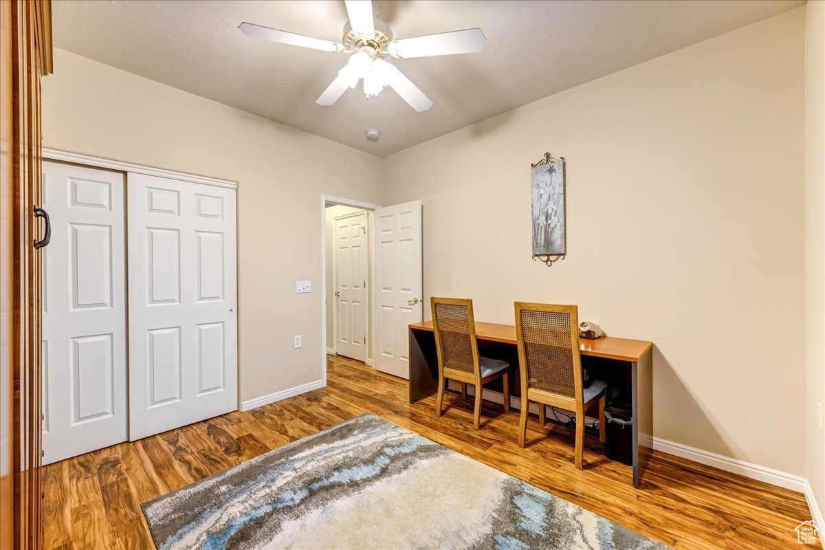 Home office featuring hardwood / wood-style flooring and ceiling fan