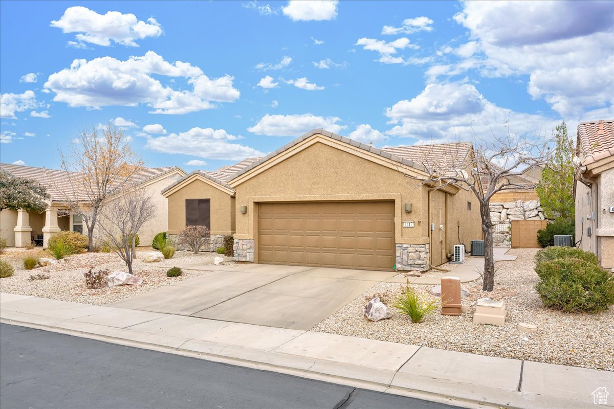 Single story home featuring a garage and central AC