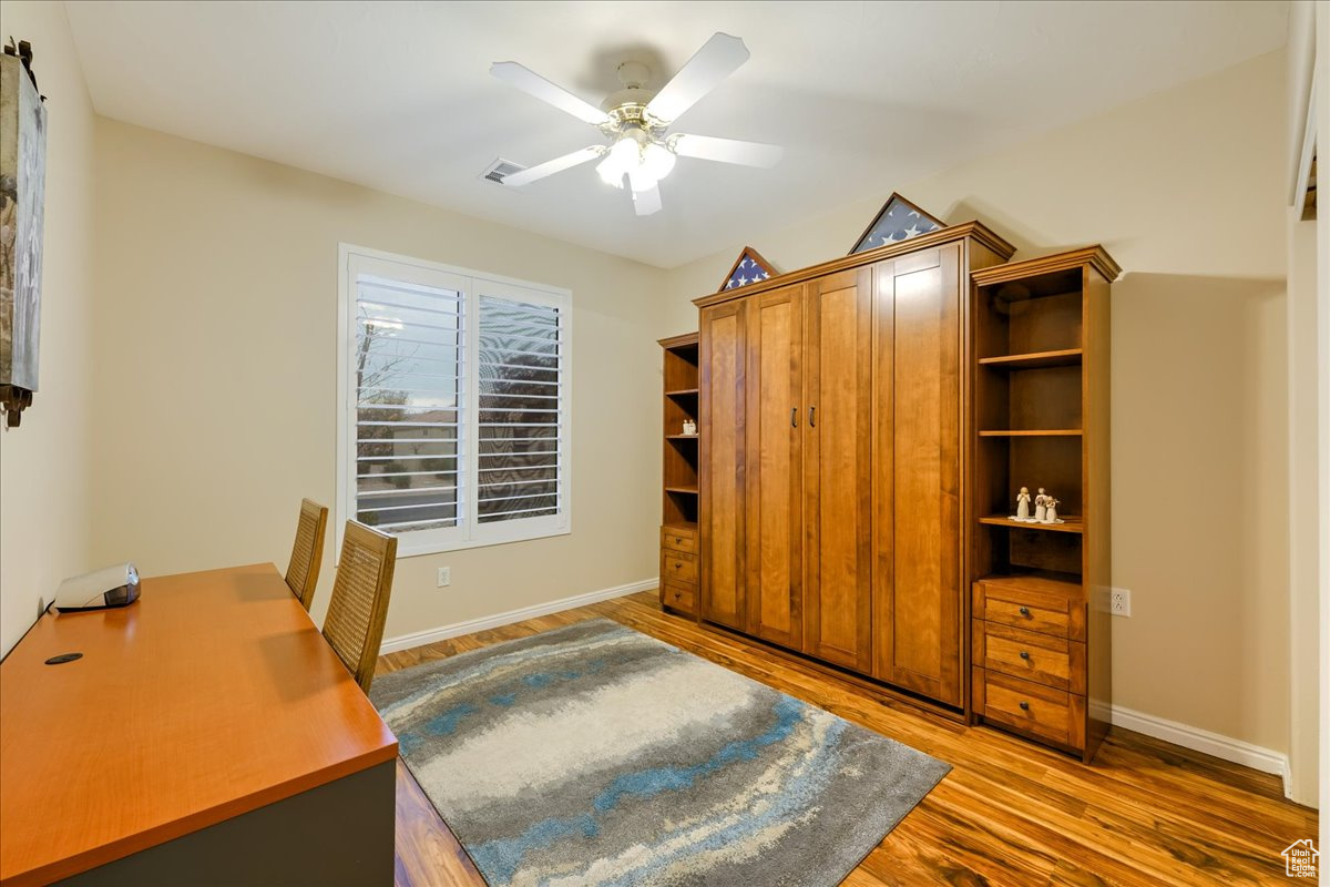 Office space featuring ceiling fan and hardwood / wood-style floors