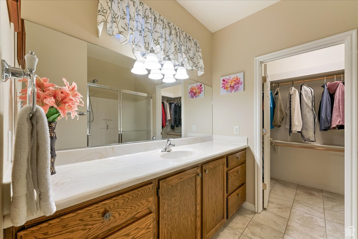 Bathroom featuring vanity and an enclosed shower