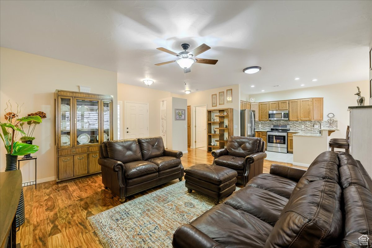 Living room featuring dark hardwood / wood-style floors and ceiling fan