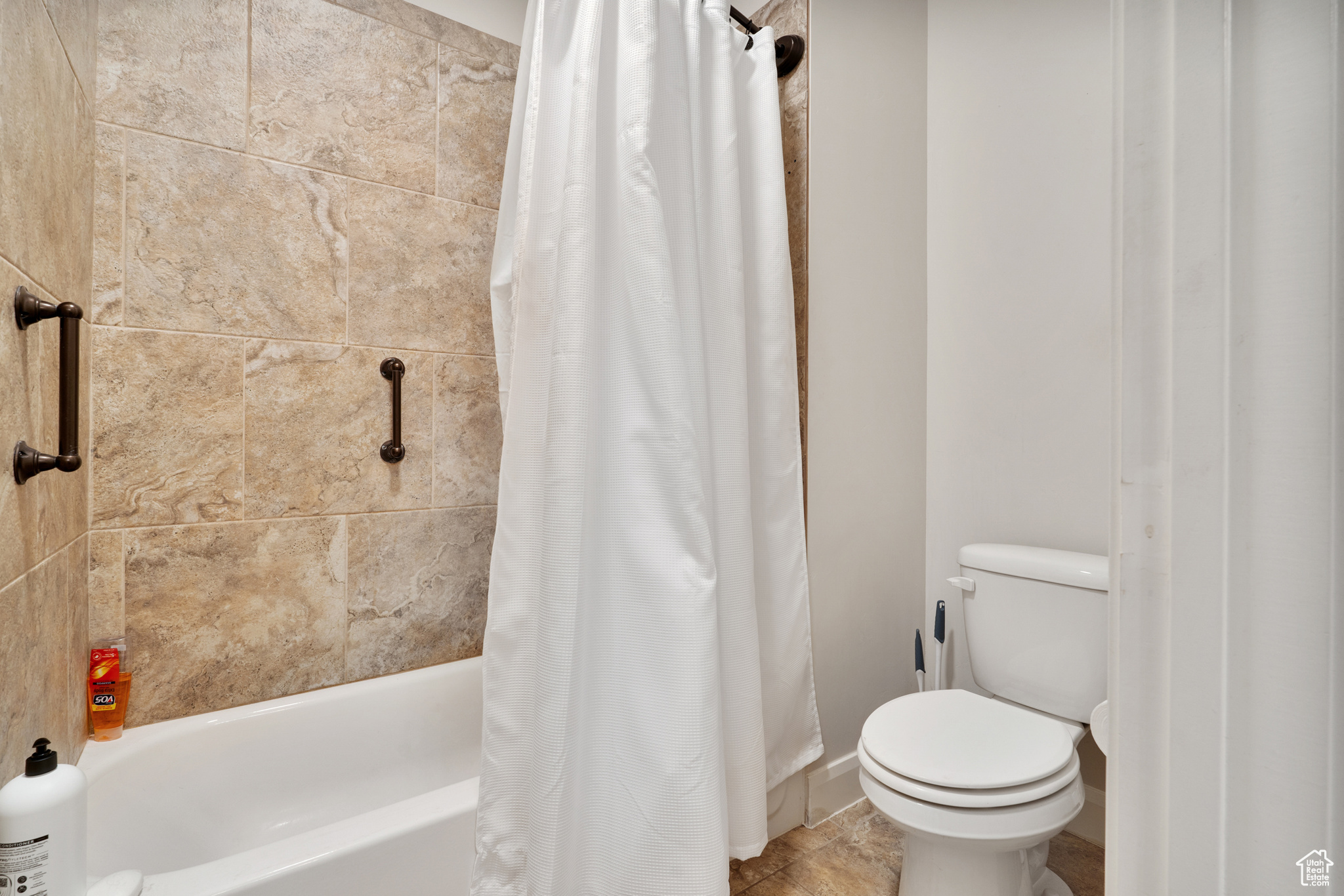 Bathroom with shower / bath combo and toilet