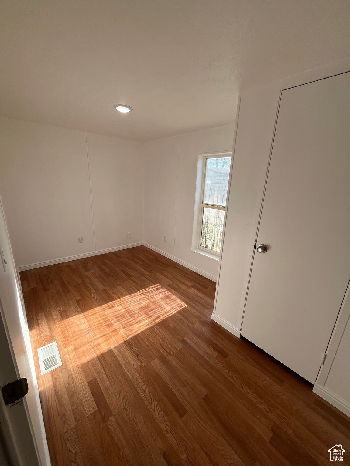 Unfurnished room featuring wood-type flooring