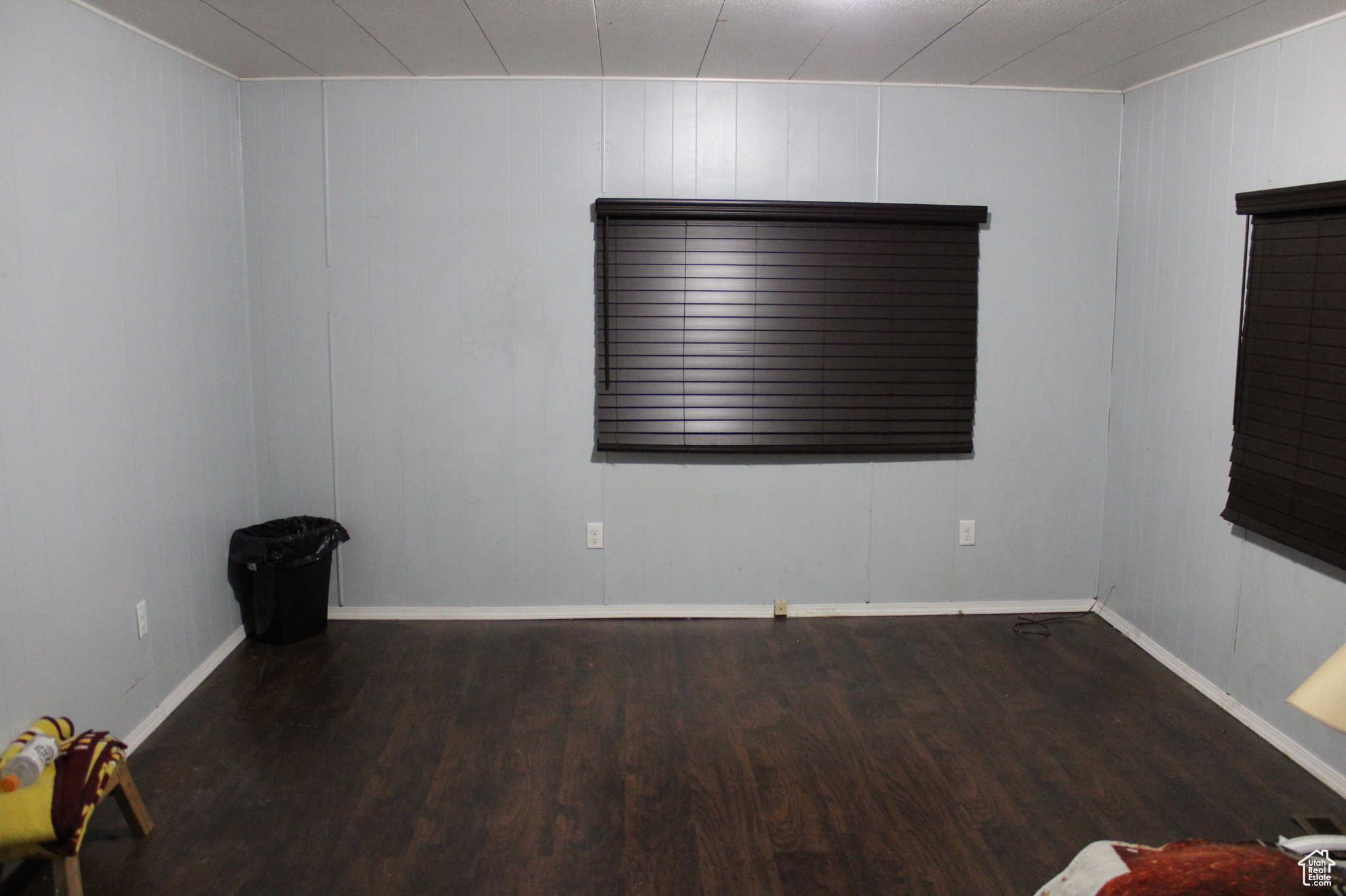 Empty room featuring dark wood-type flooring