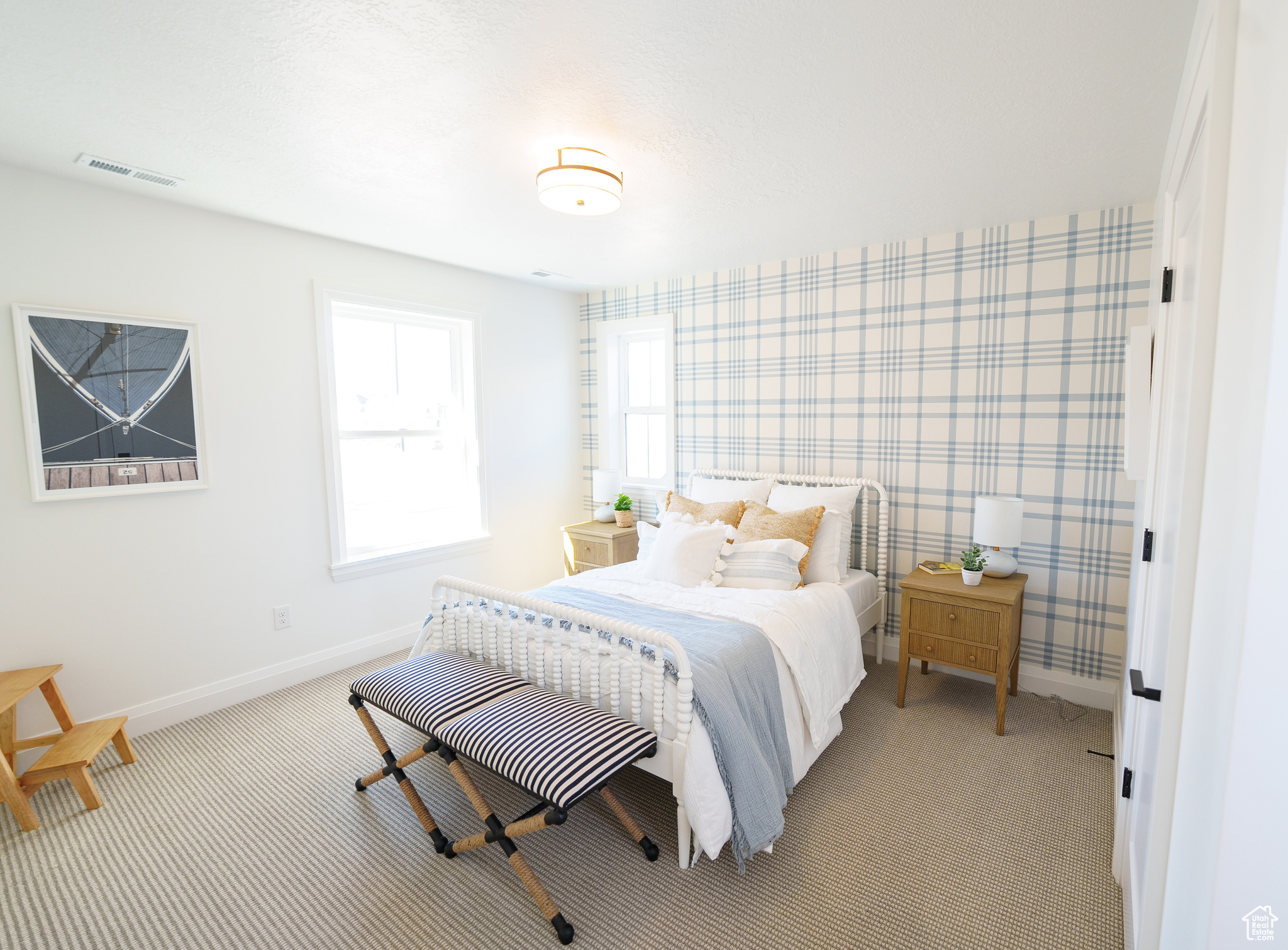 Bedroom featuring light carpet