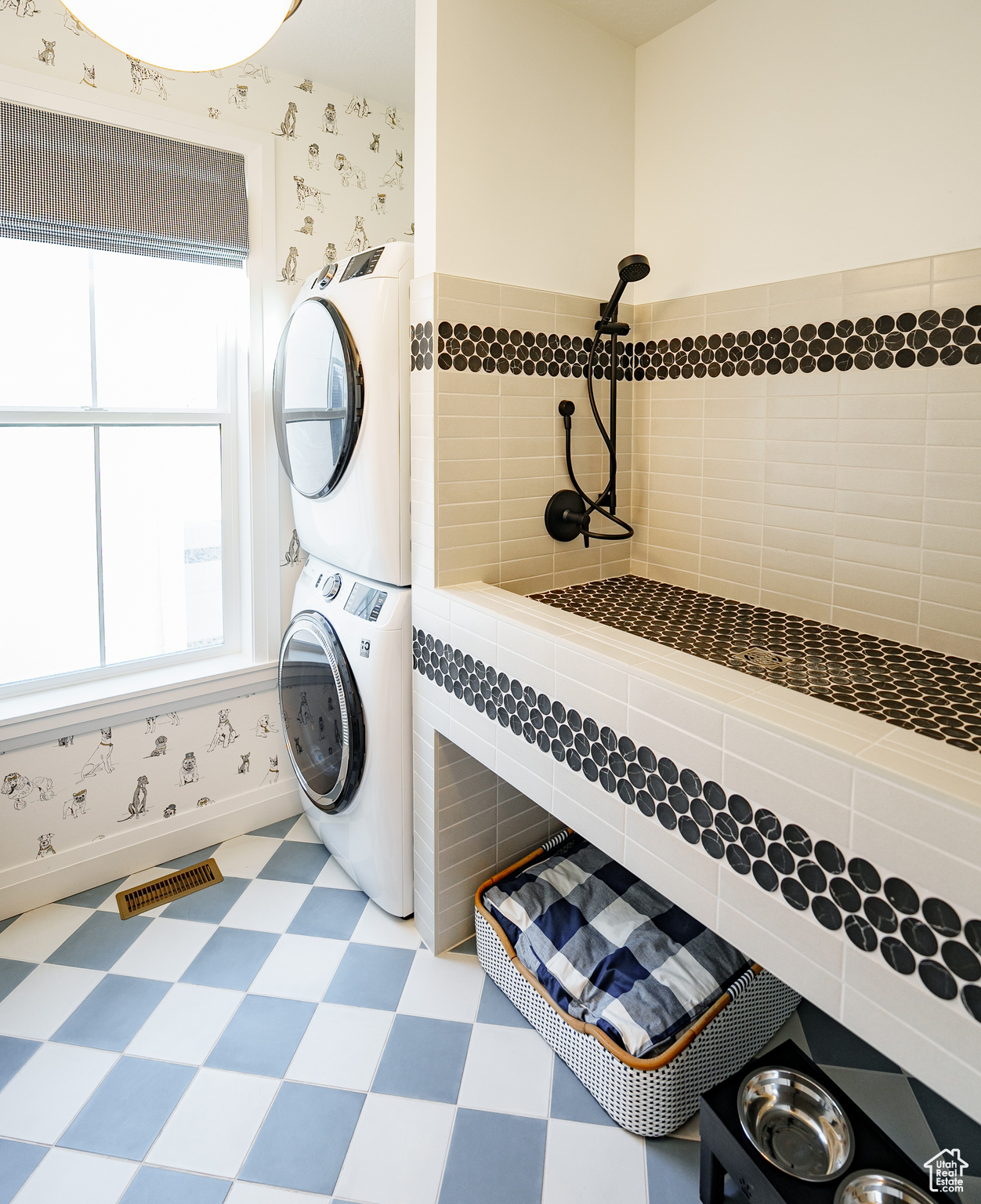 Clothes washing area featuring stacked washer / dryer