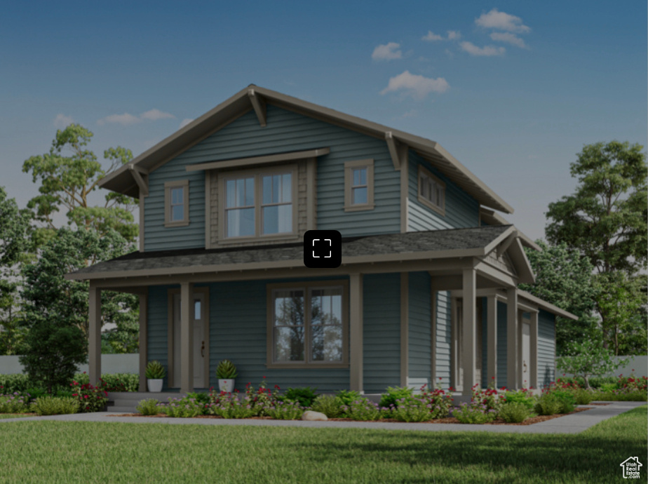 View of front of home with a porch and a front yard