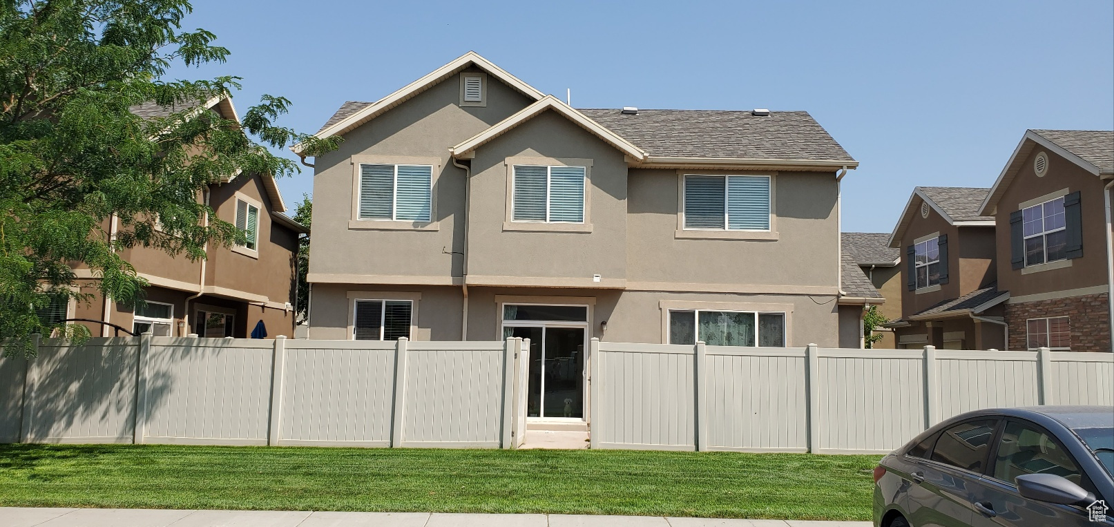 Back of property featuring a lawn