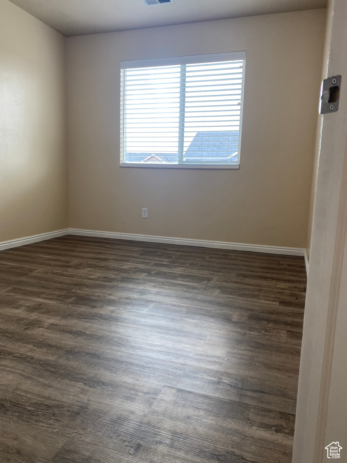 Unfurnished room featuring dark hardwood / wood-style floors