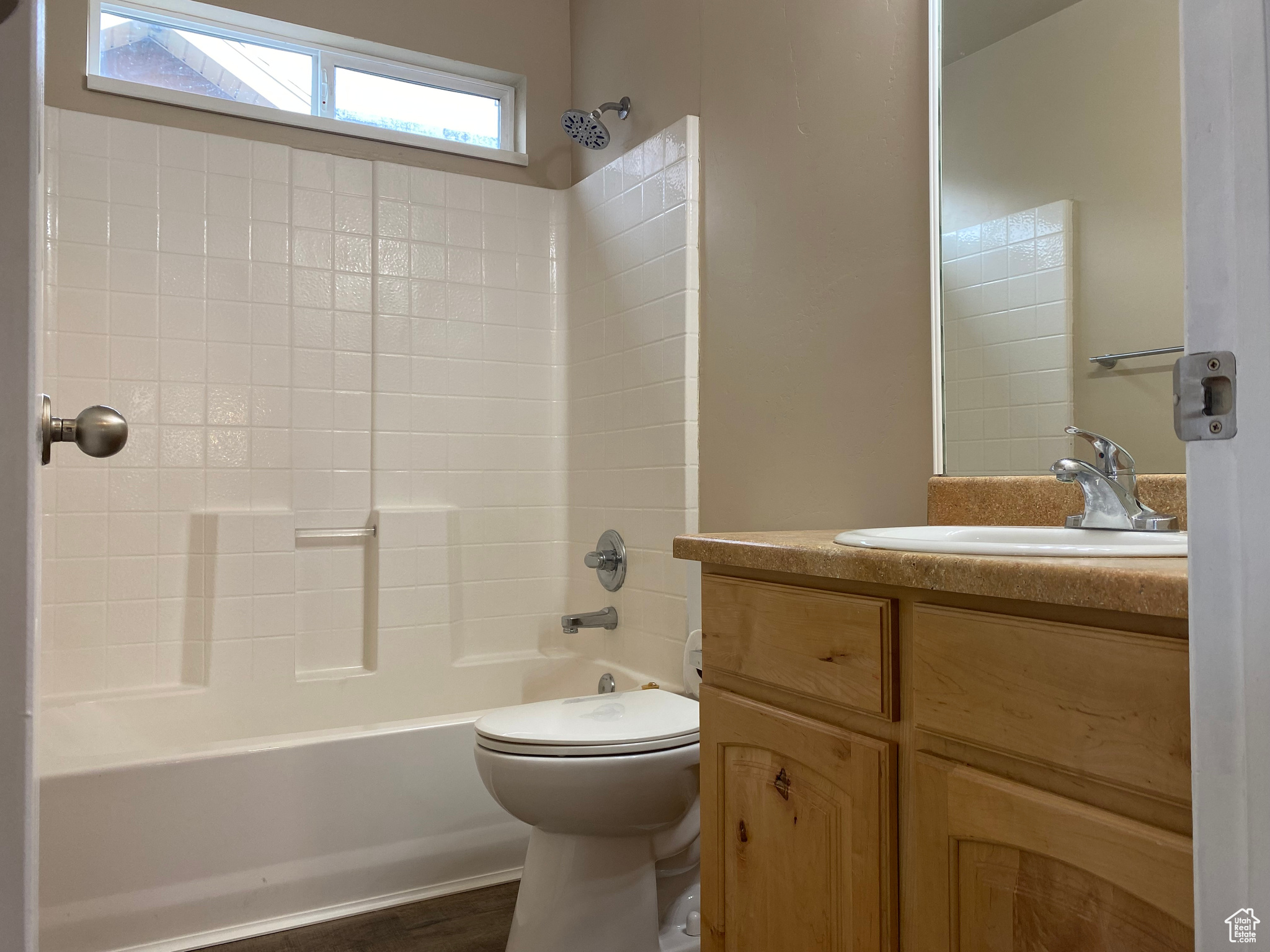 Full bathroom with vanity, hardwood / wood-style floors, shower / bathing tub combination, and toilet