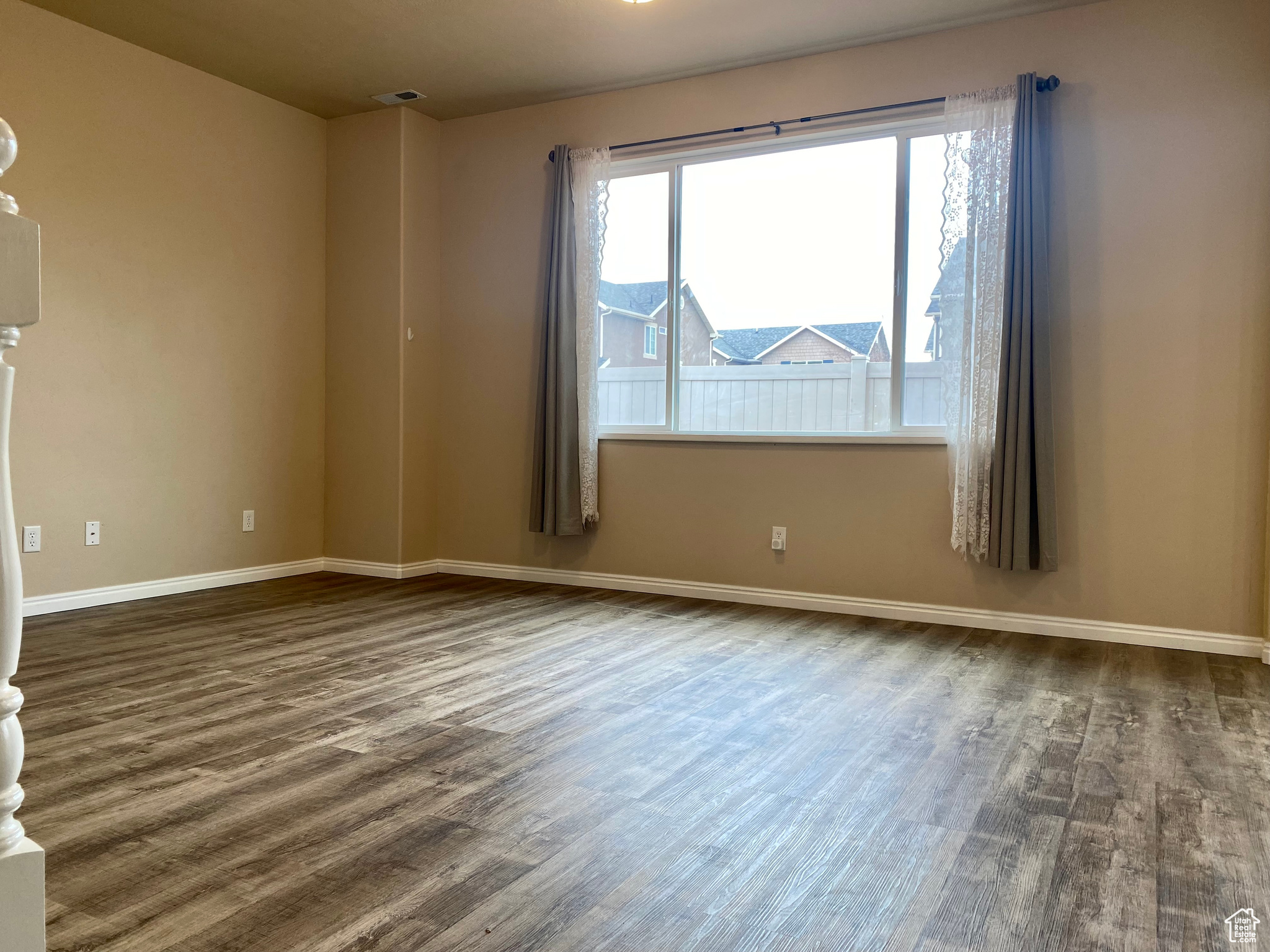 Empty room with dark wood-type flooring