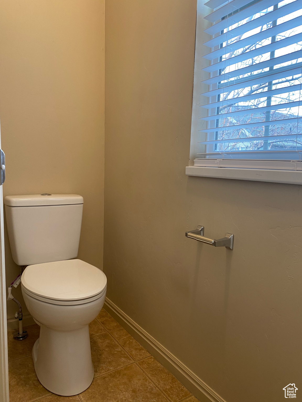 Bathroom featuring tile patterned flooring and toilet