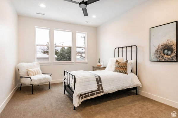 Bedroom with ceiling fan and carpet floors