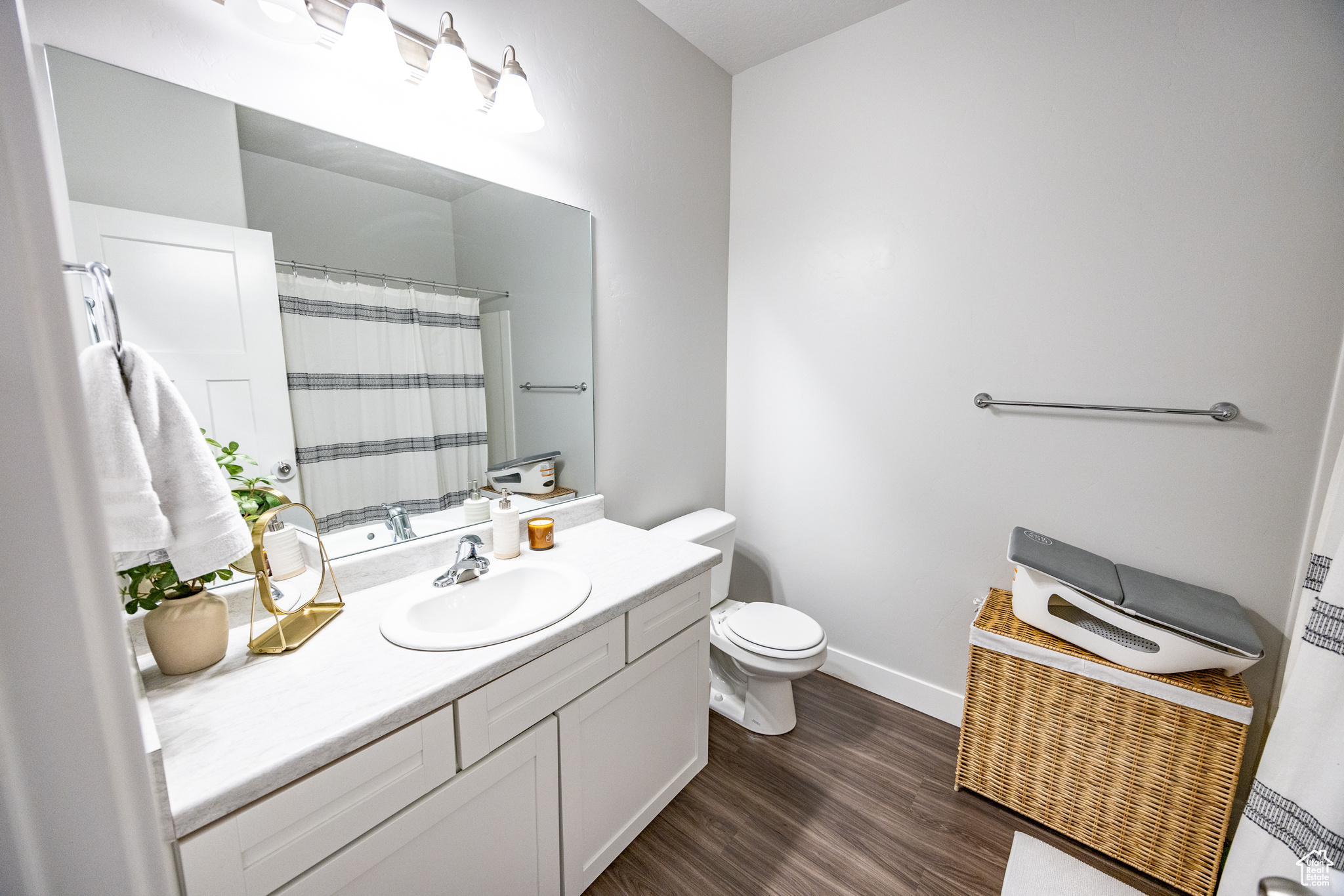 Bathroom featuring hardwood / wood-style flooring, vanity, and toilet