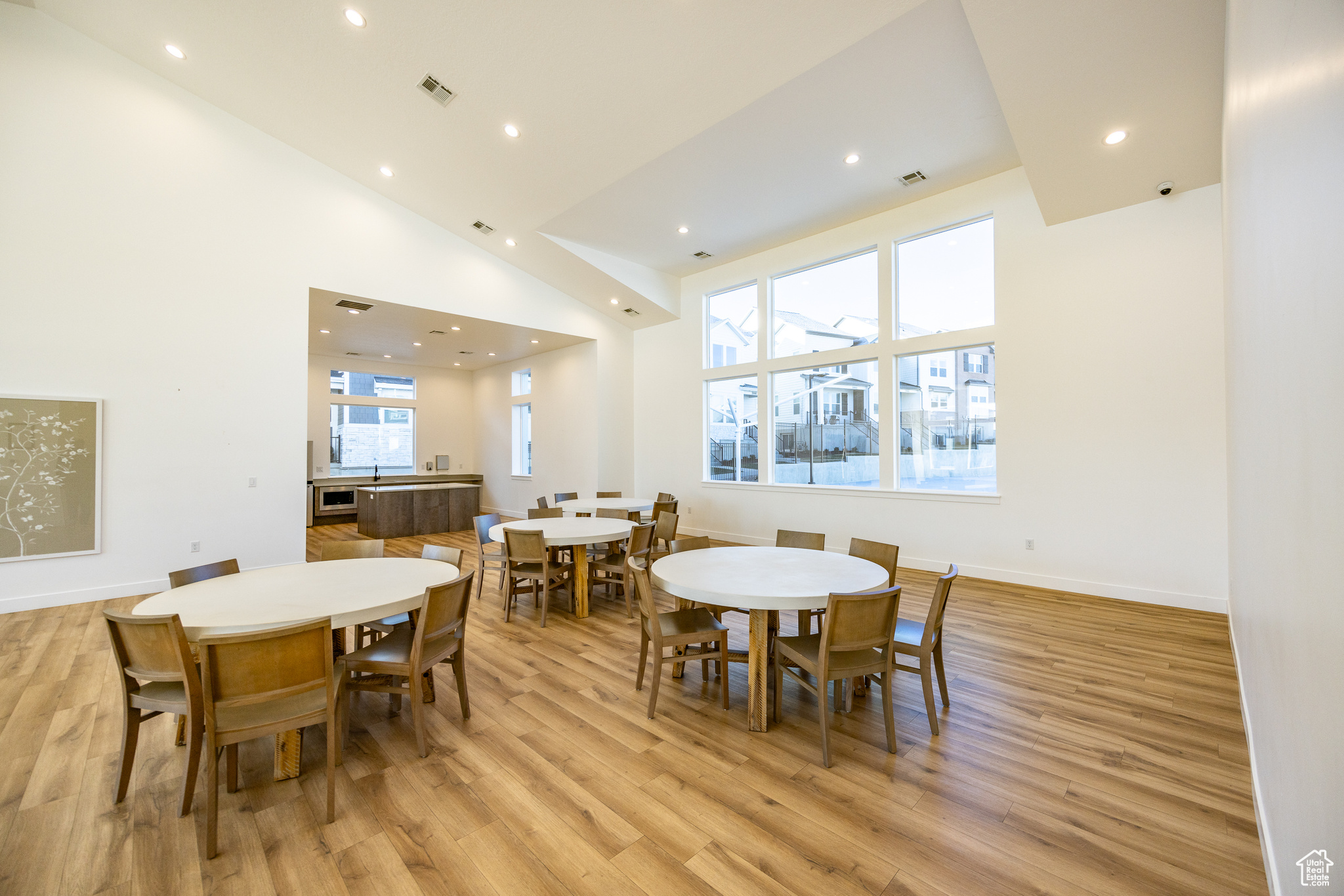 Dining space featuring light hardwood / wood-style floors and high vaulted ceiling