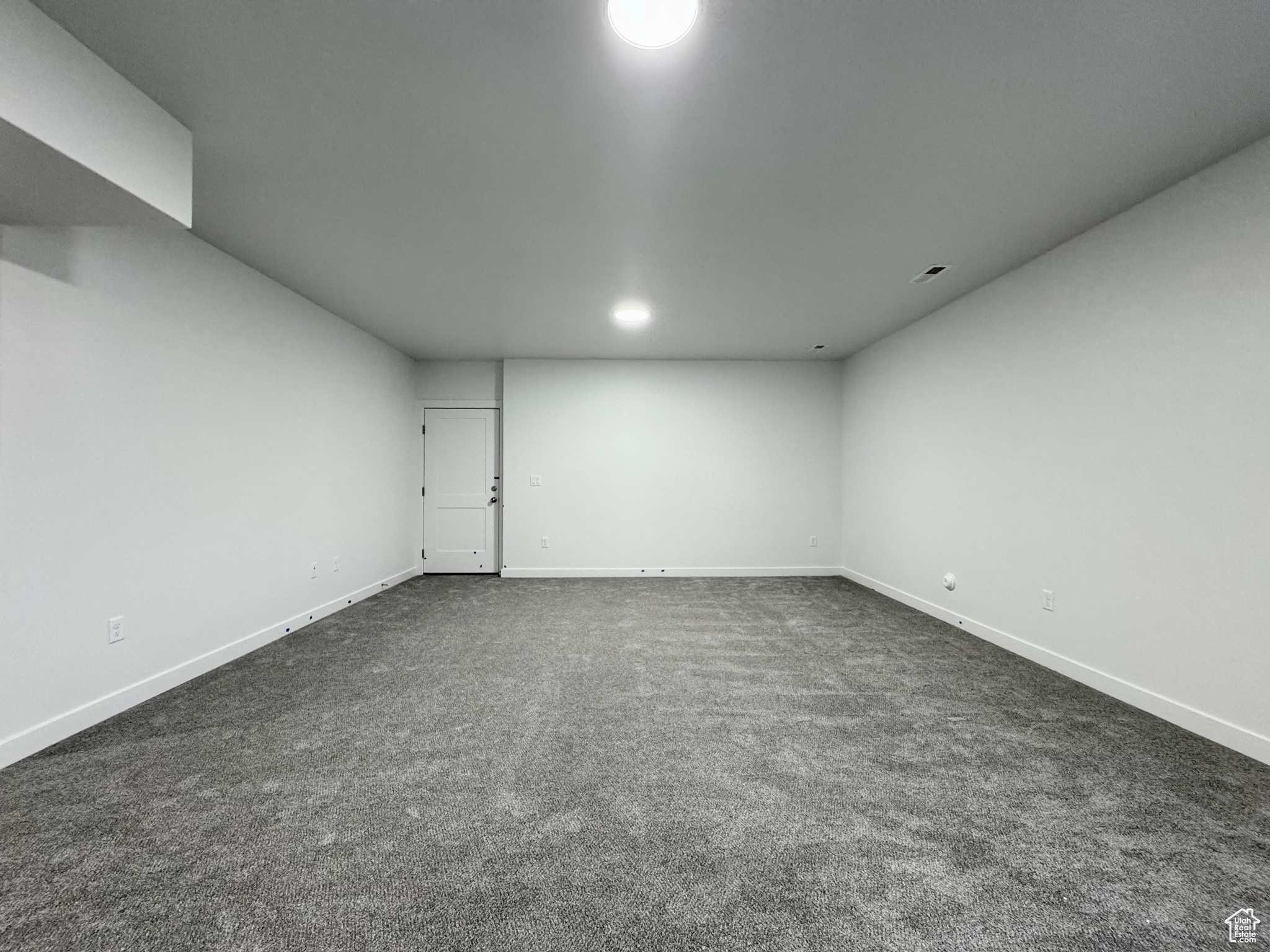 Spare room with dark carpet