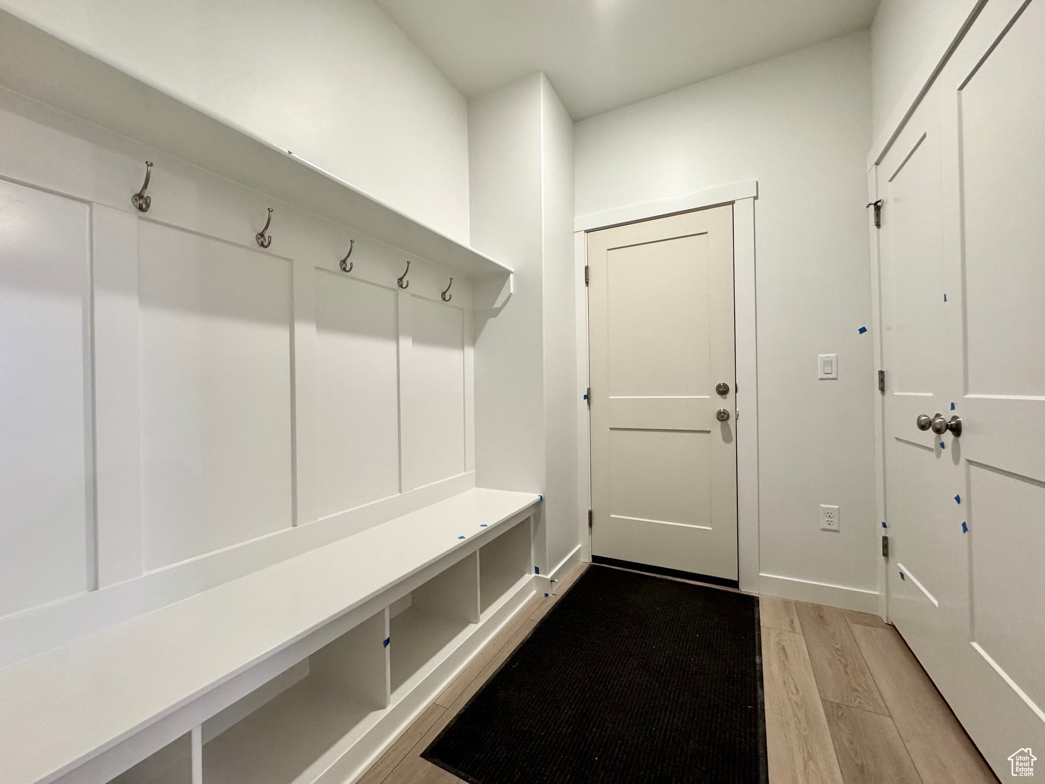 Mudroom with light hardwood / wood-style floors