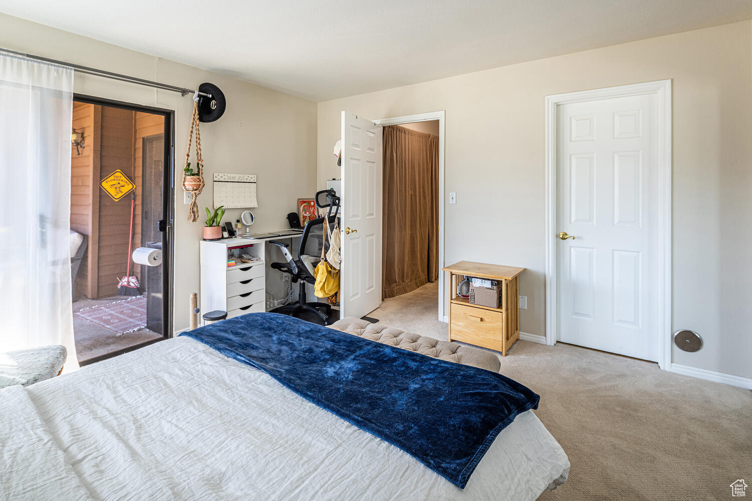 Bedroom featuring light carpet