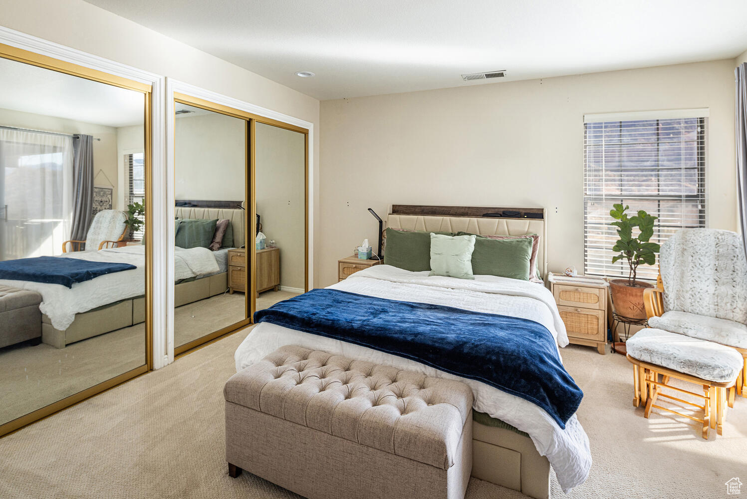 Carpeted bedroom with two closets