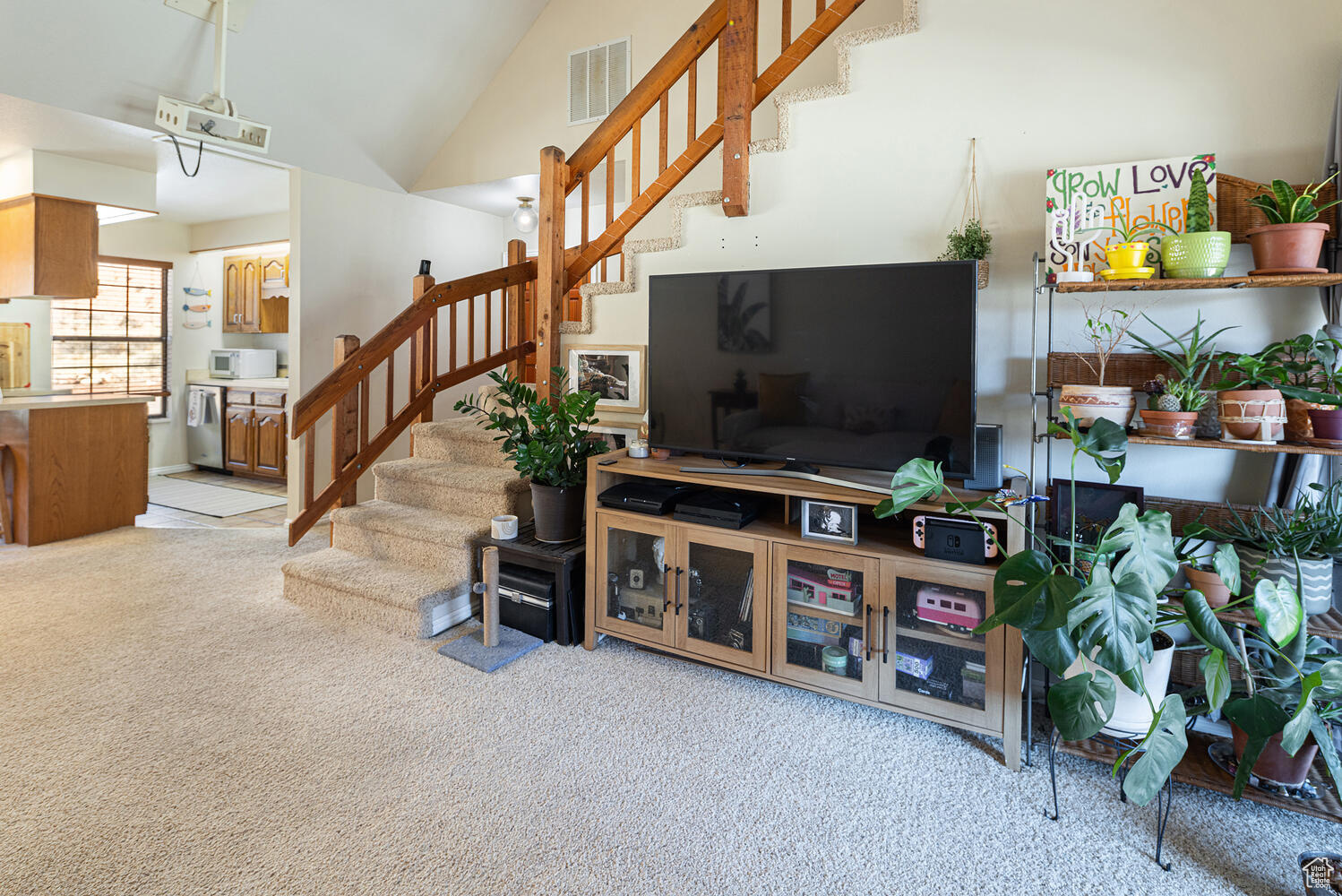 Carpeted living room with lofted ceiling