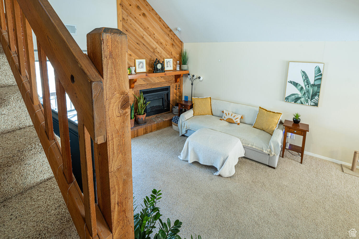 Living room with carpet flooring and wooden walls