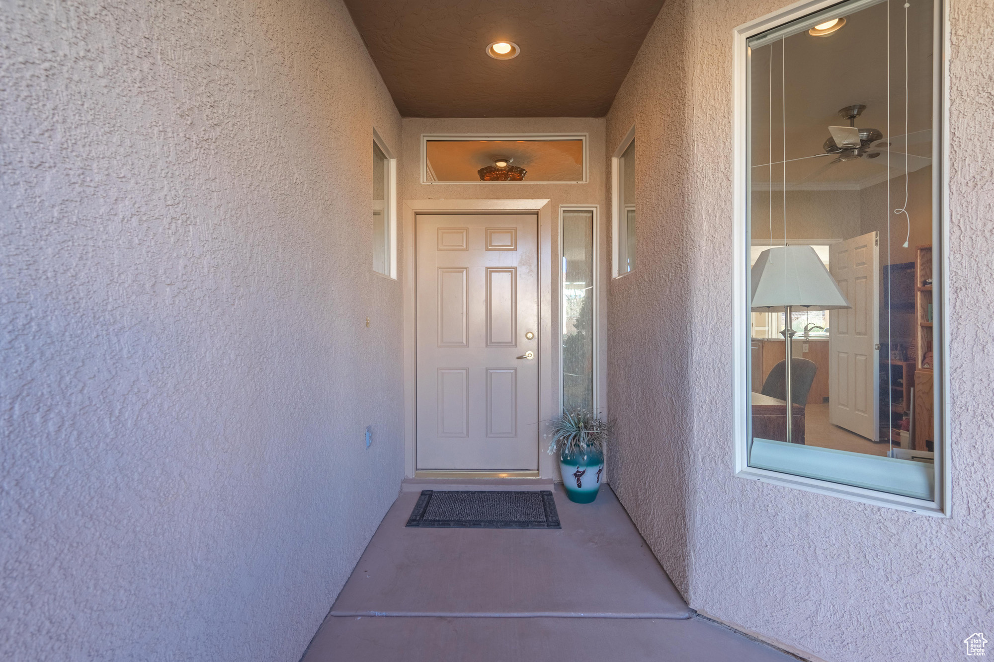 View of cvered front entry w/transom window