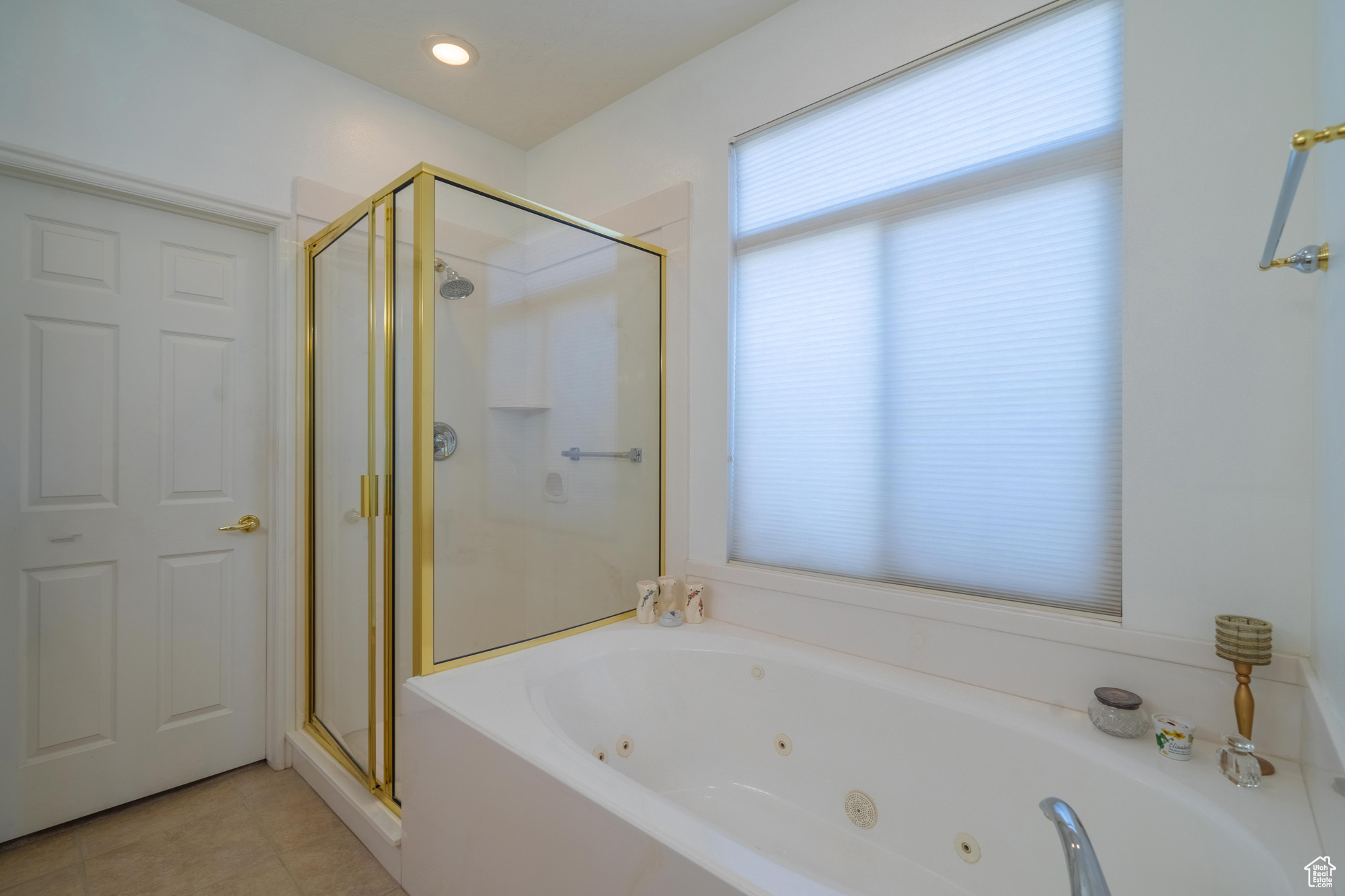 Bathroom with tile patterned flooring and independent shower and bath