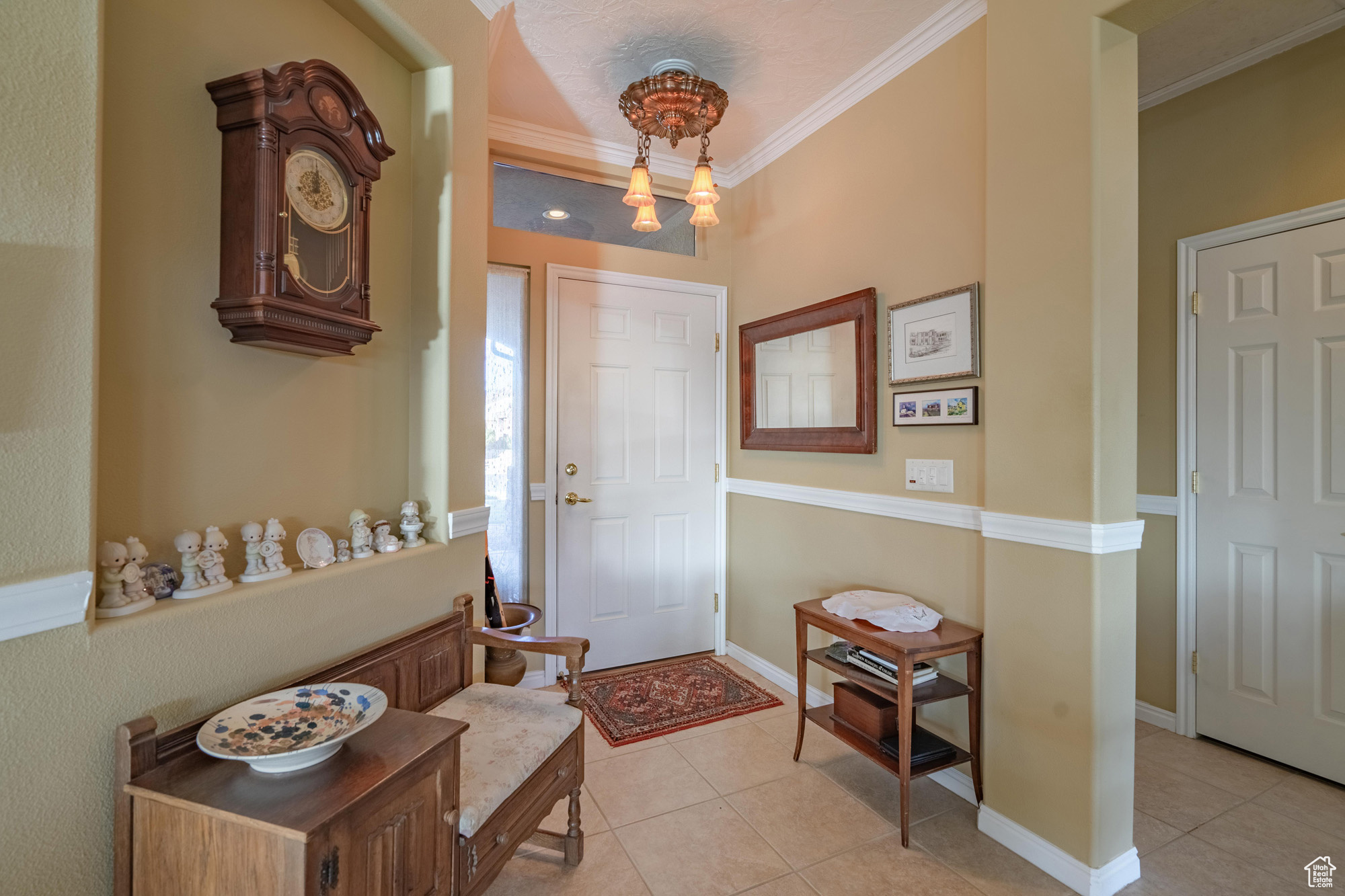 Tiled entrance foyer featuring ornamental molding