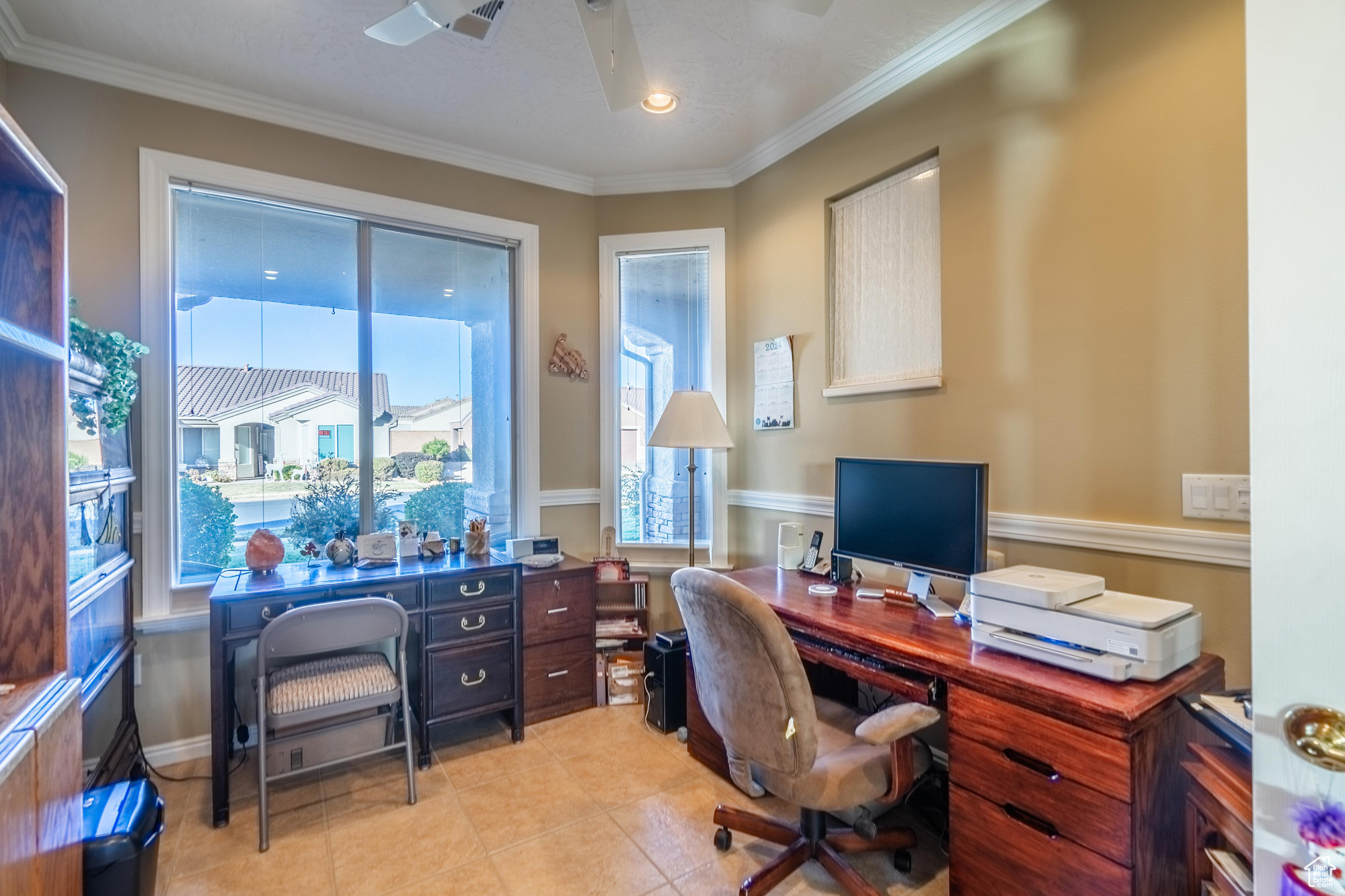 Home office with crown molding, light tile patterned floors, and ceiling fan