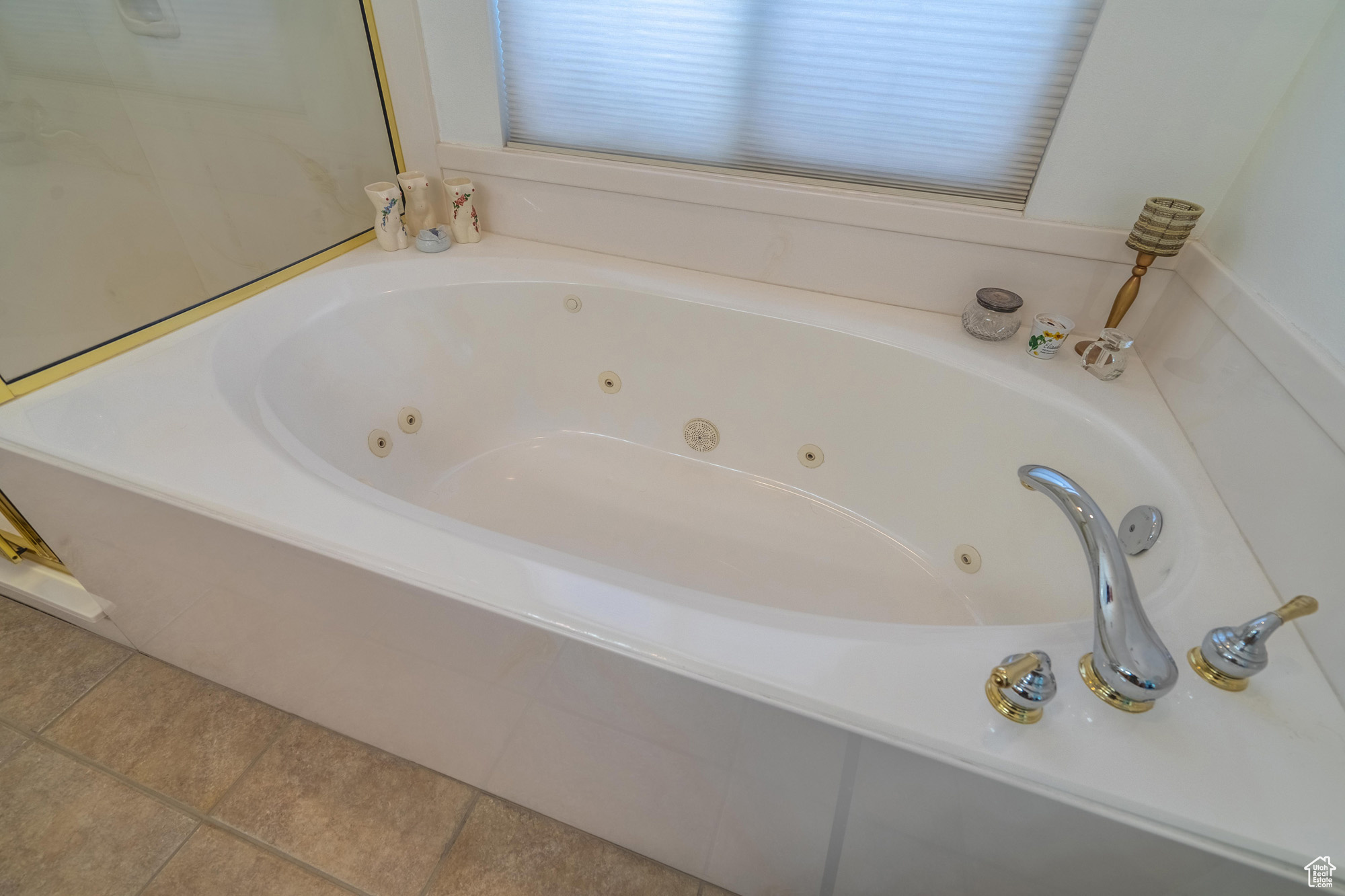 Bathroom featuring tile patterned floors and jetted bathtub