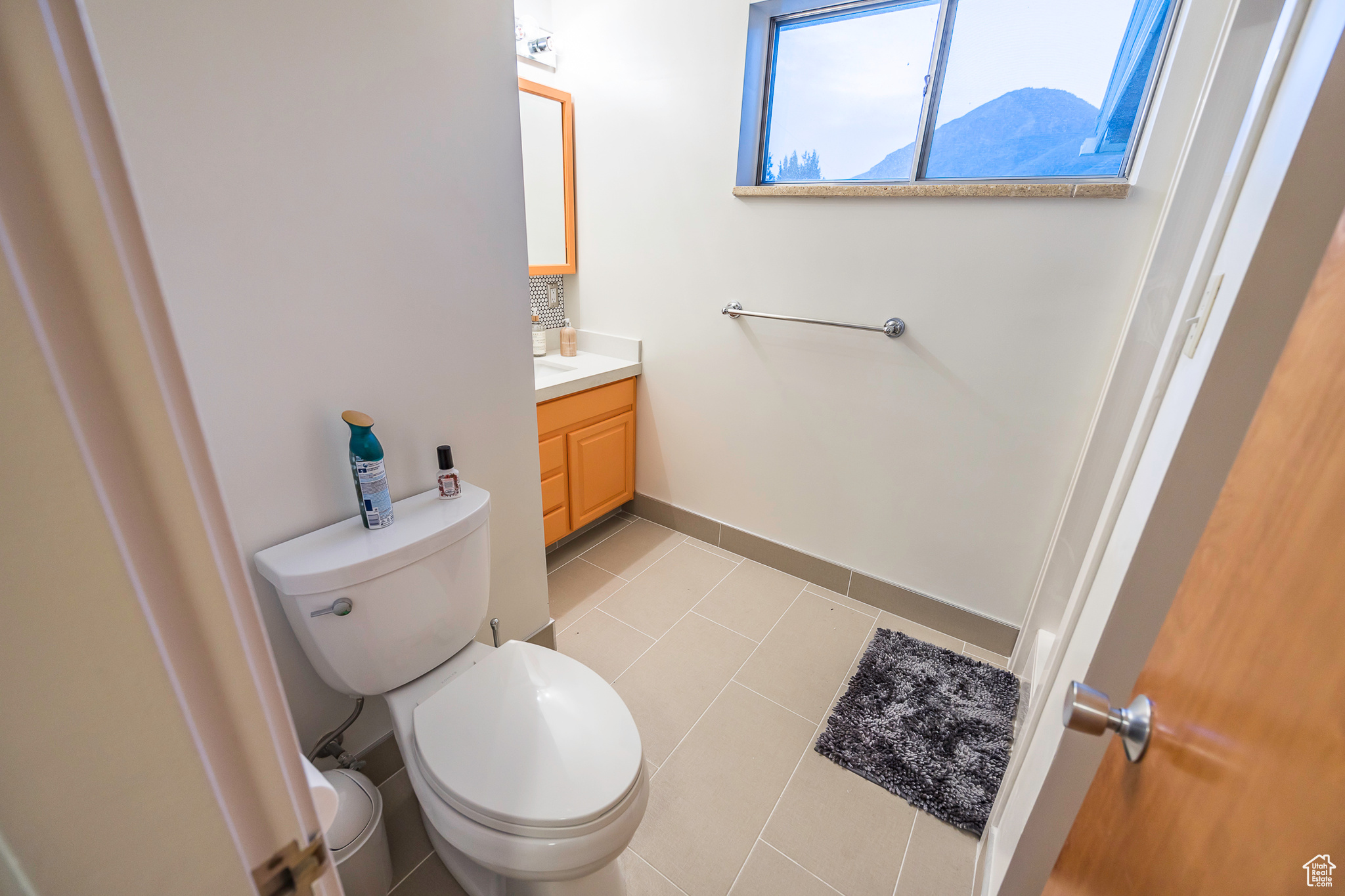 Bathroom with tile patterned floors, vanity, and toilet