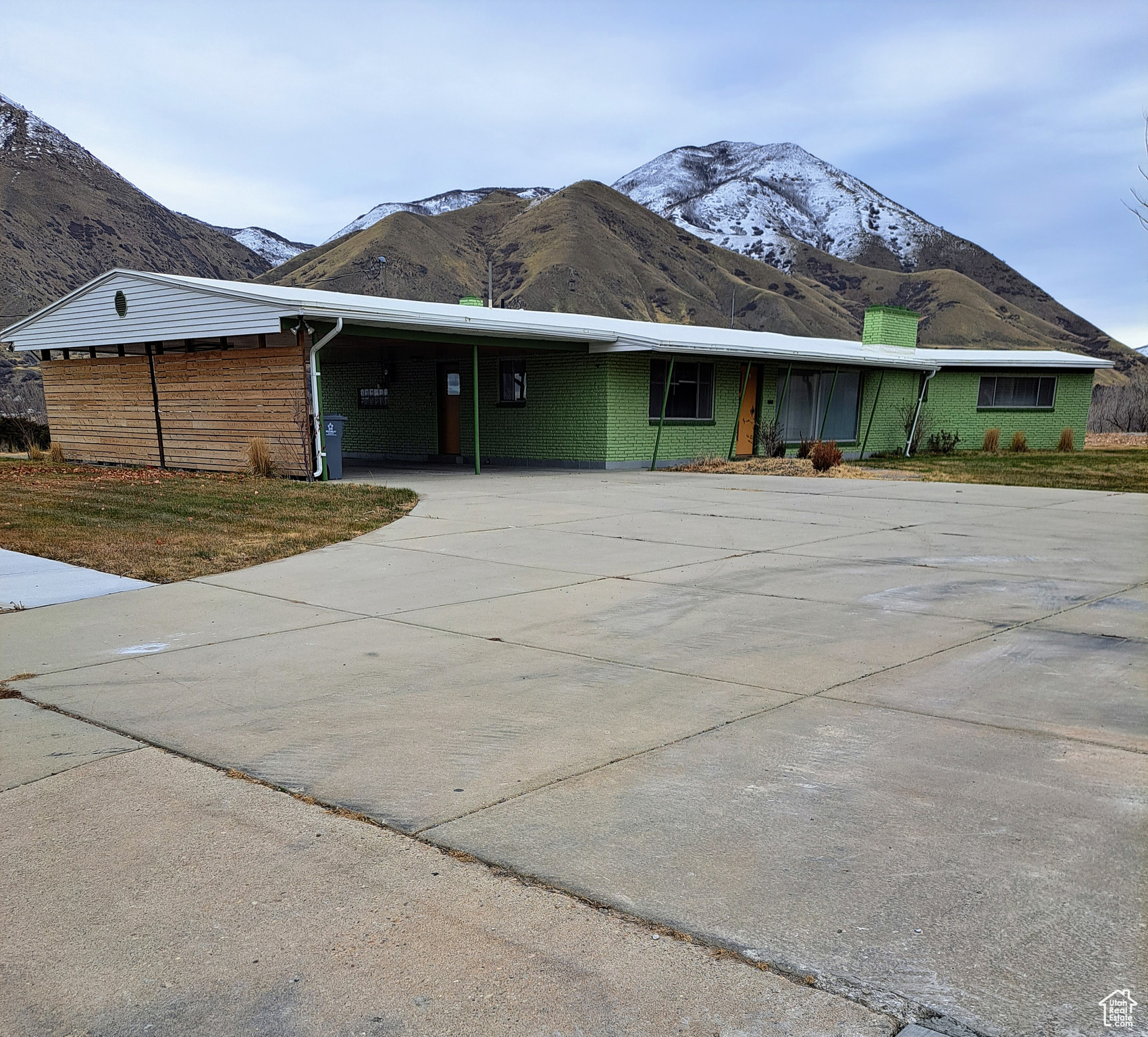 Single story home with a mountain view and a carport