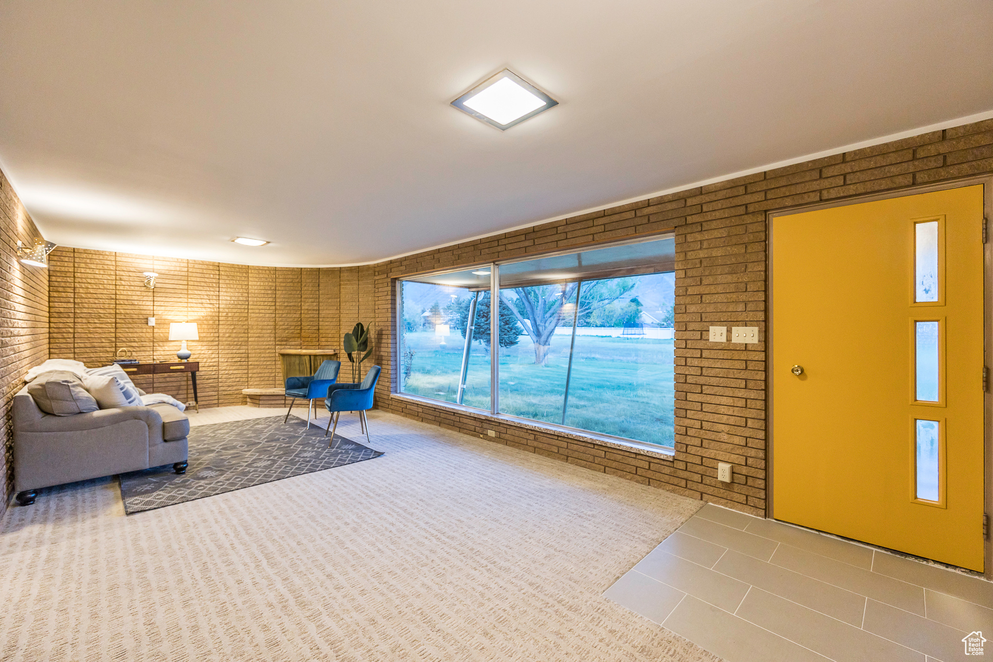 Unfurnished living room with brick wall