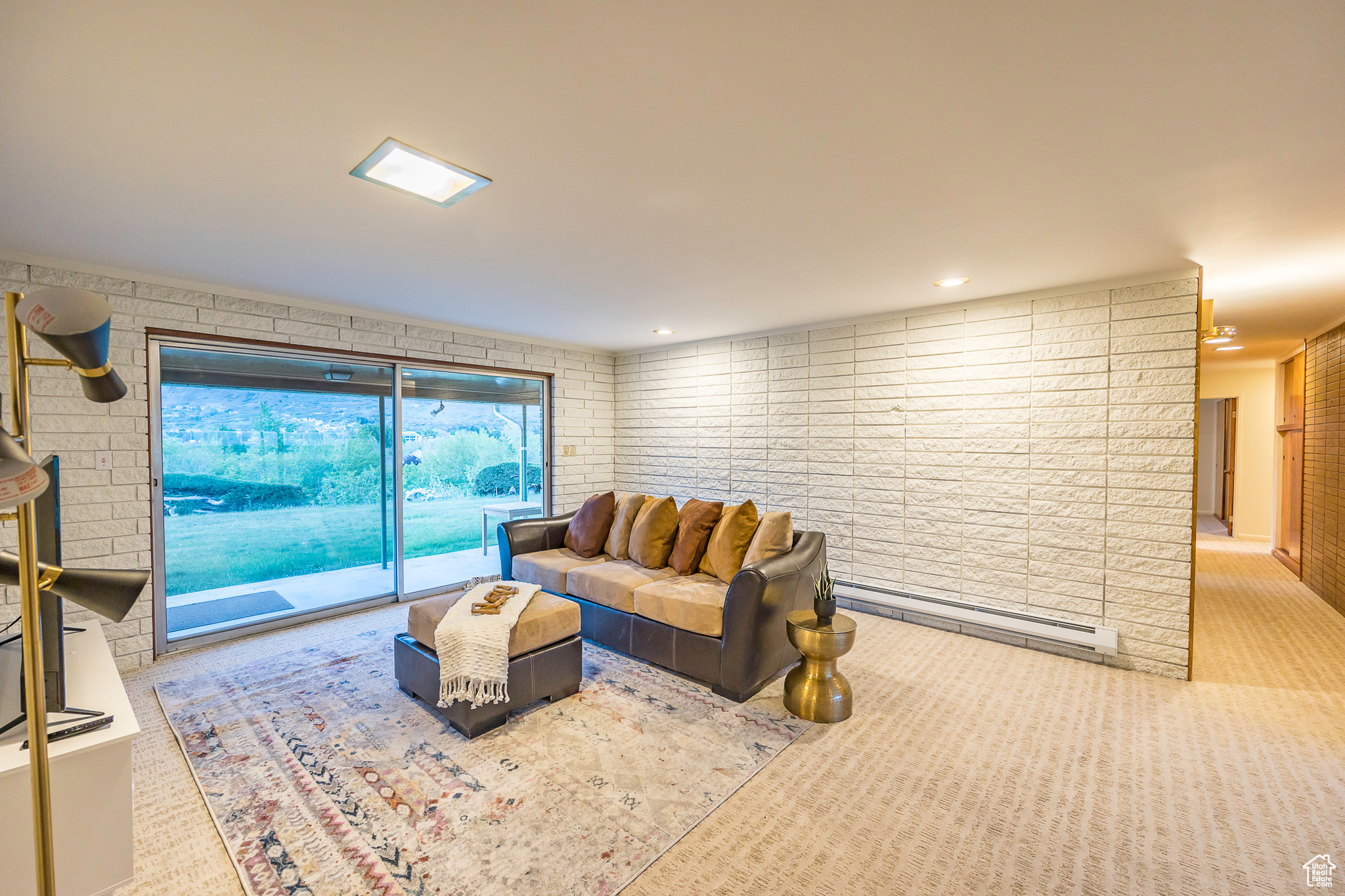 Carpeted living room featuring baseboard heating