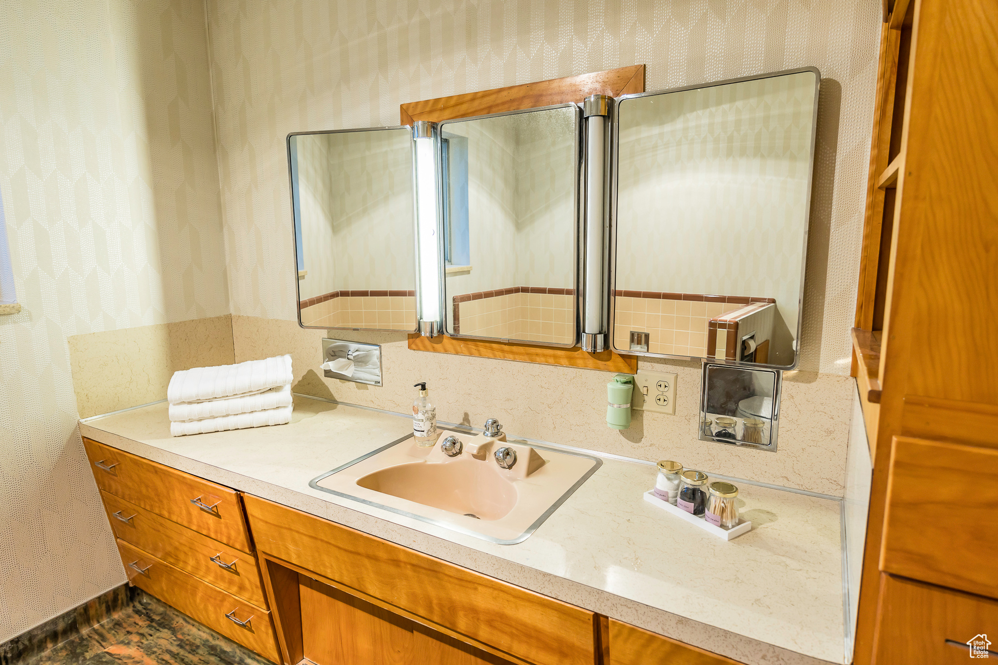 Bathroom with vanity and tasteful backsplash