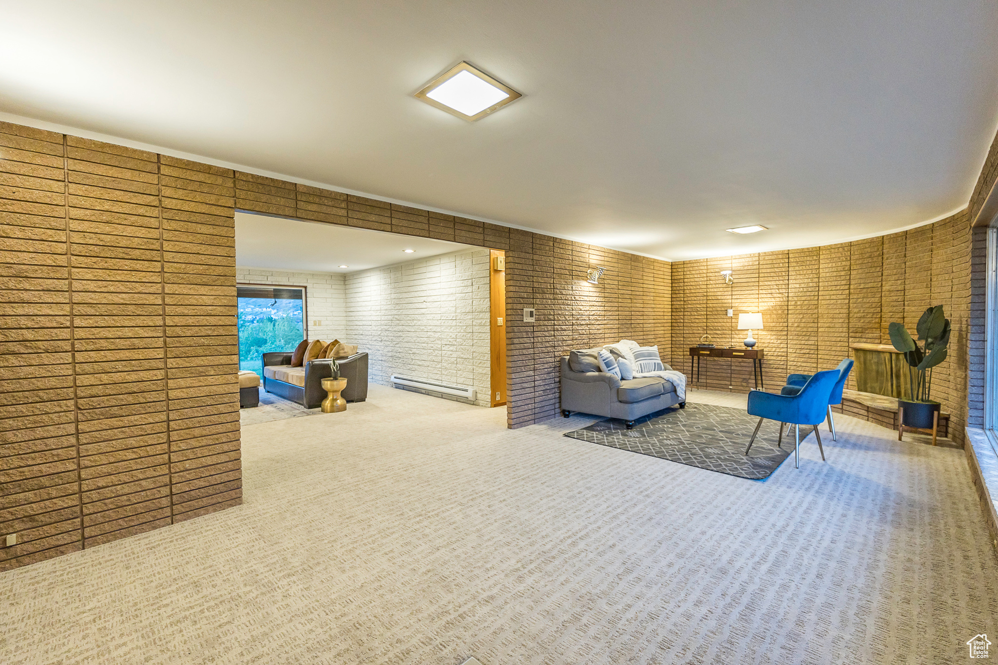 Carpeted living room featuring a baseboard heating unit