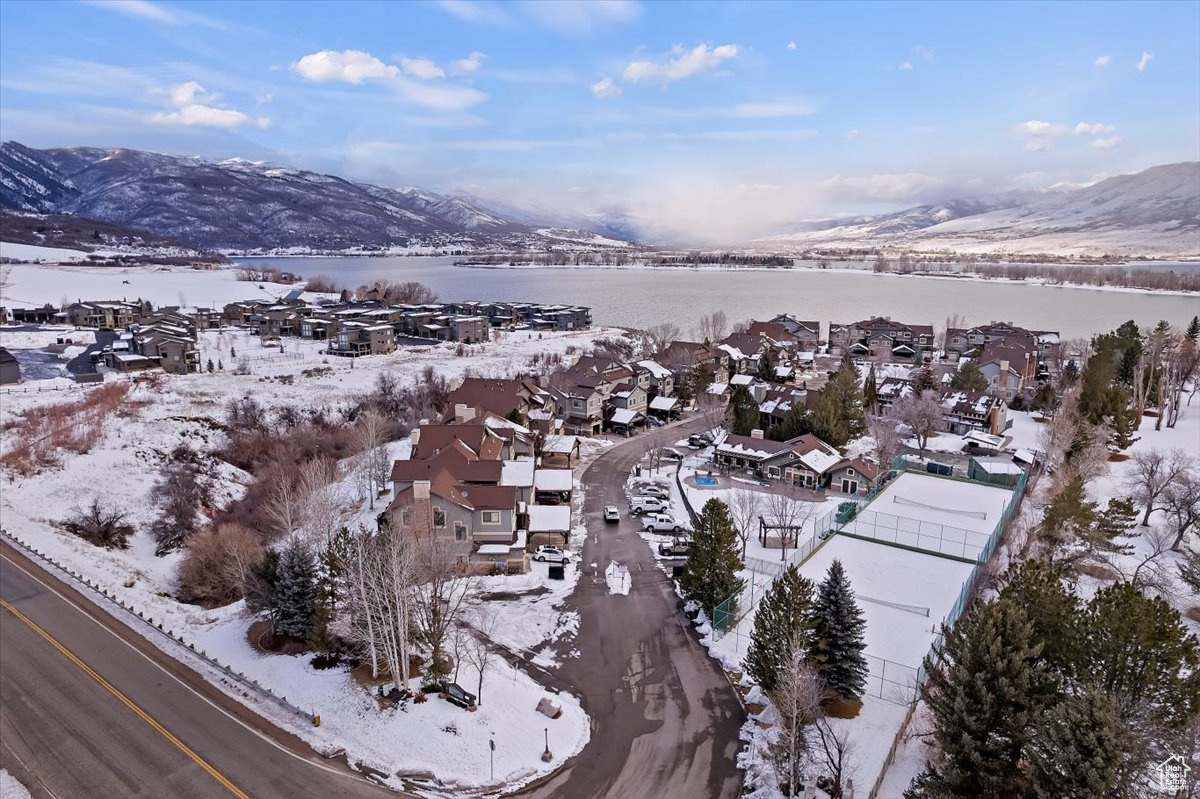 Snowy aerial view with a water and mountain view