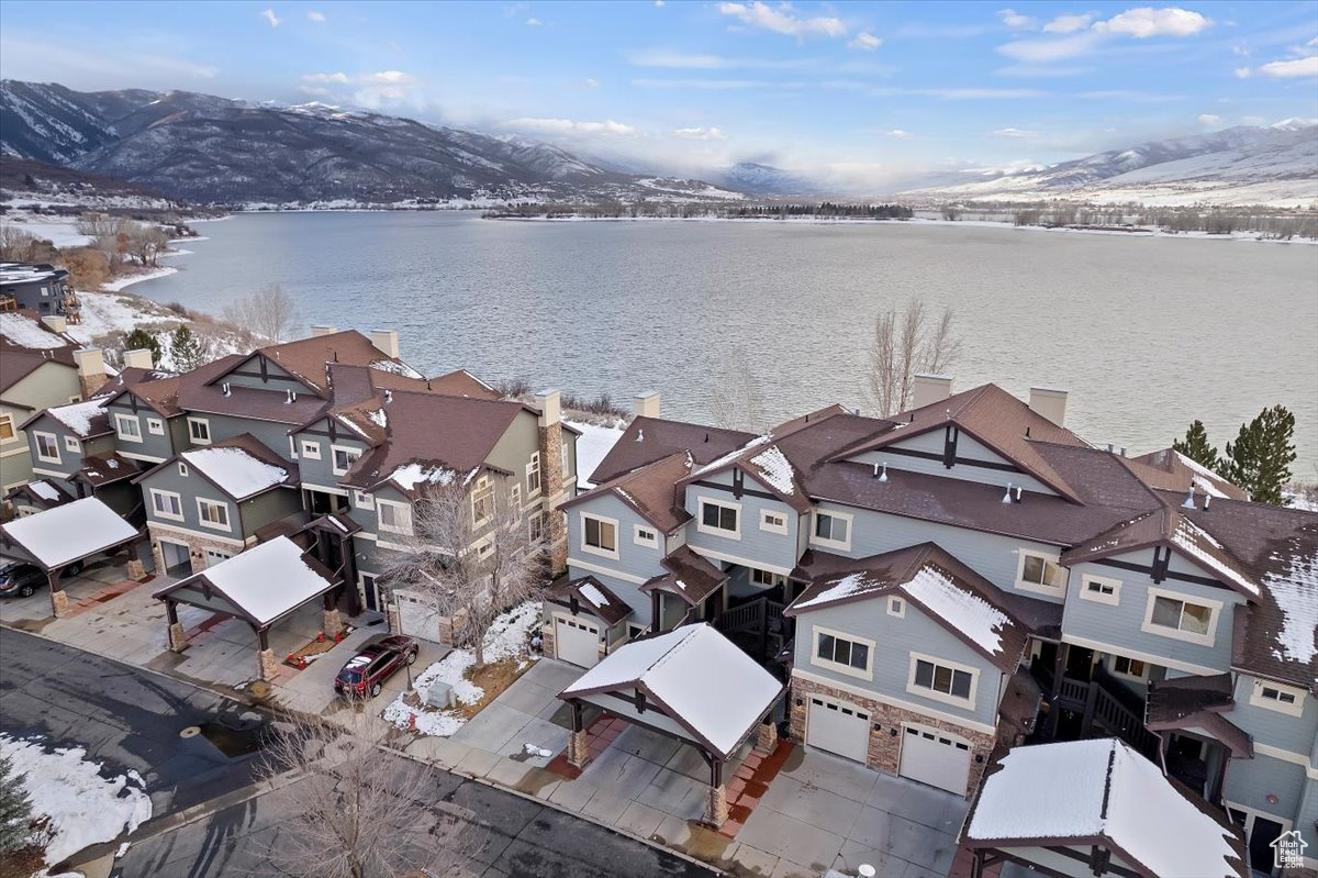 Snowy aerial view with a water and mountain view