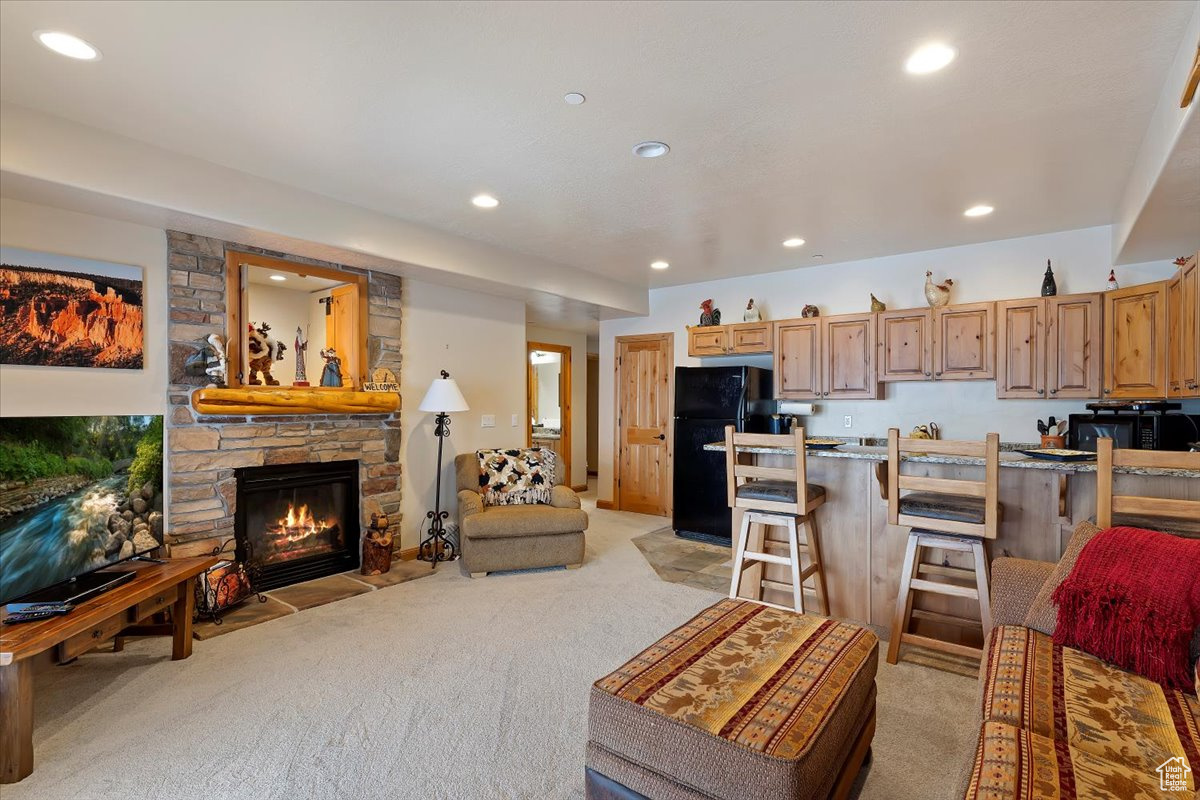 Carpeted living room featuring a gas fireplace