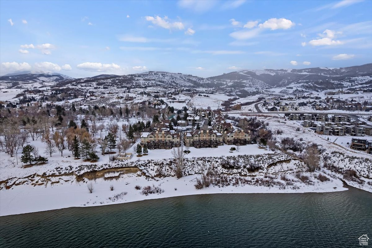 Snowy aerial view with a water and mountain view