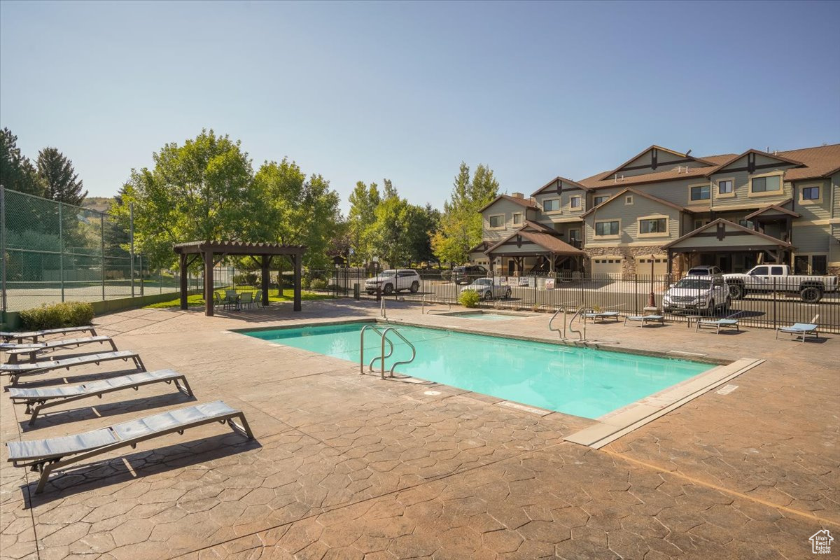 View of pool featuring a pergola and a patio area