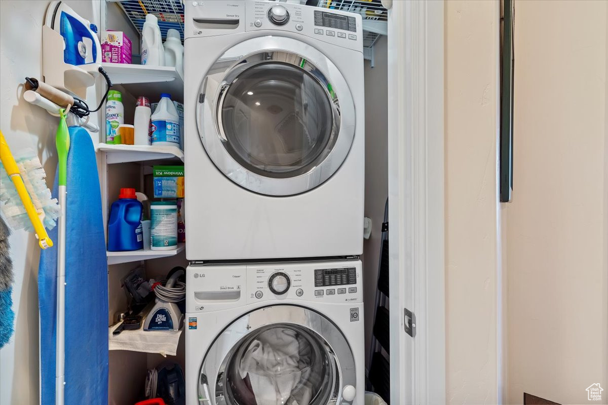 Washroom featuring stacked washer / dryer