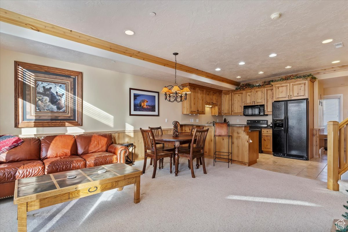 Interior space with a textured ceiling, crown molding, and a notable chandelier