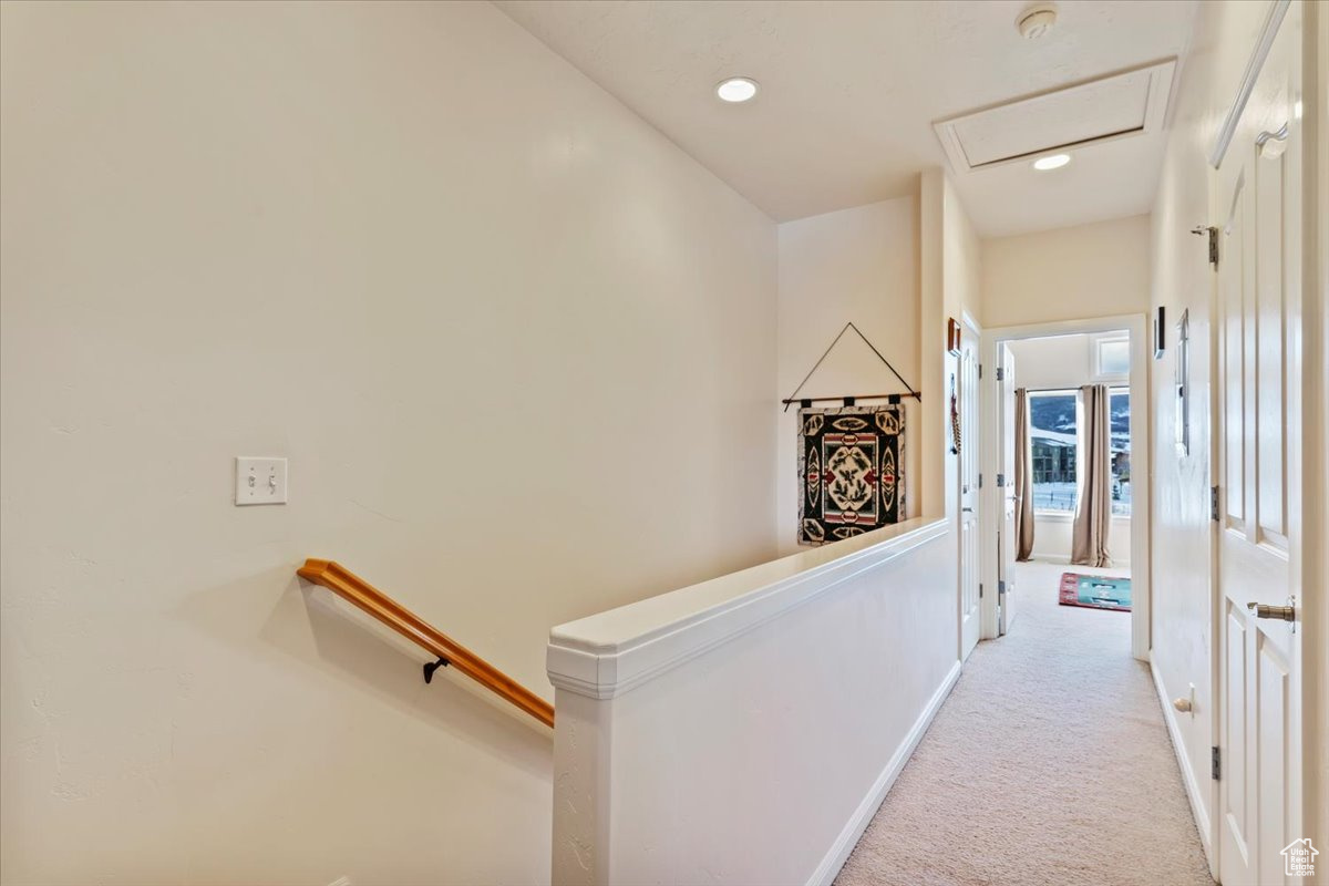 Hallway with light colored carpet