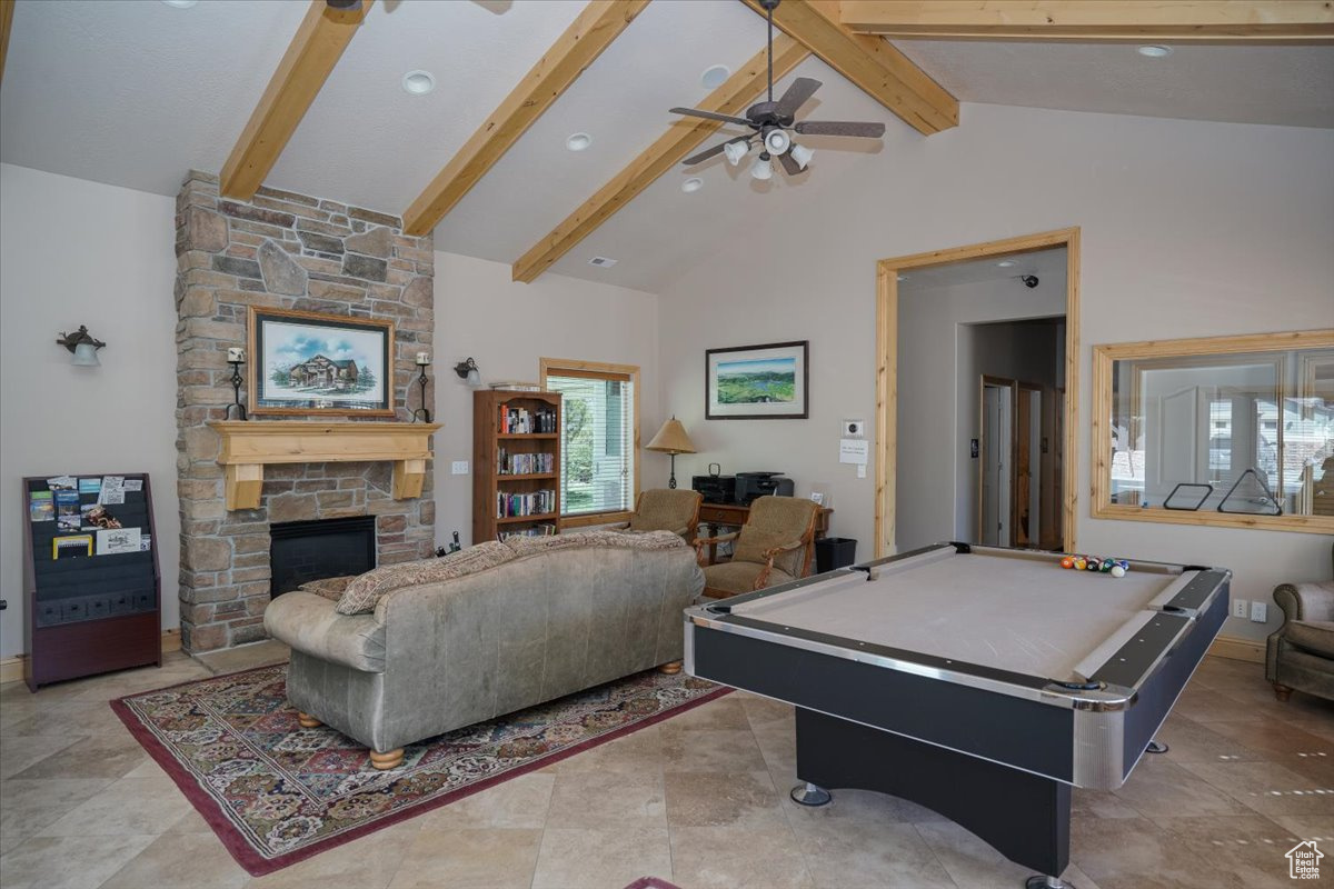 Club House Recreation room with ceiling fan, beam ceiling, high vaulted ceiling, billiards, and a stone fireplace