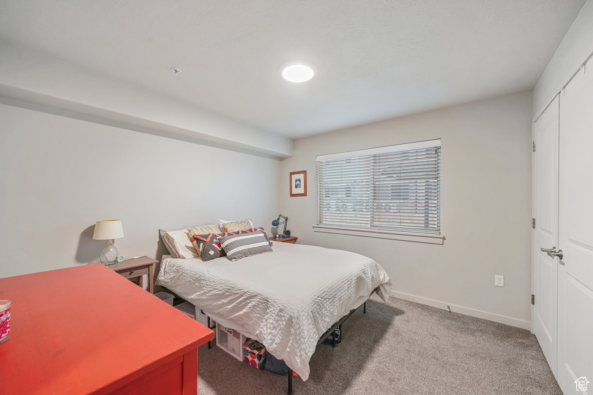 Bedroom featuring carpet flooring and a closet