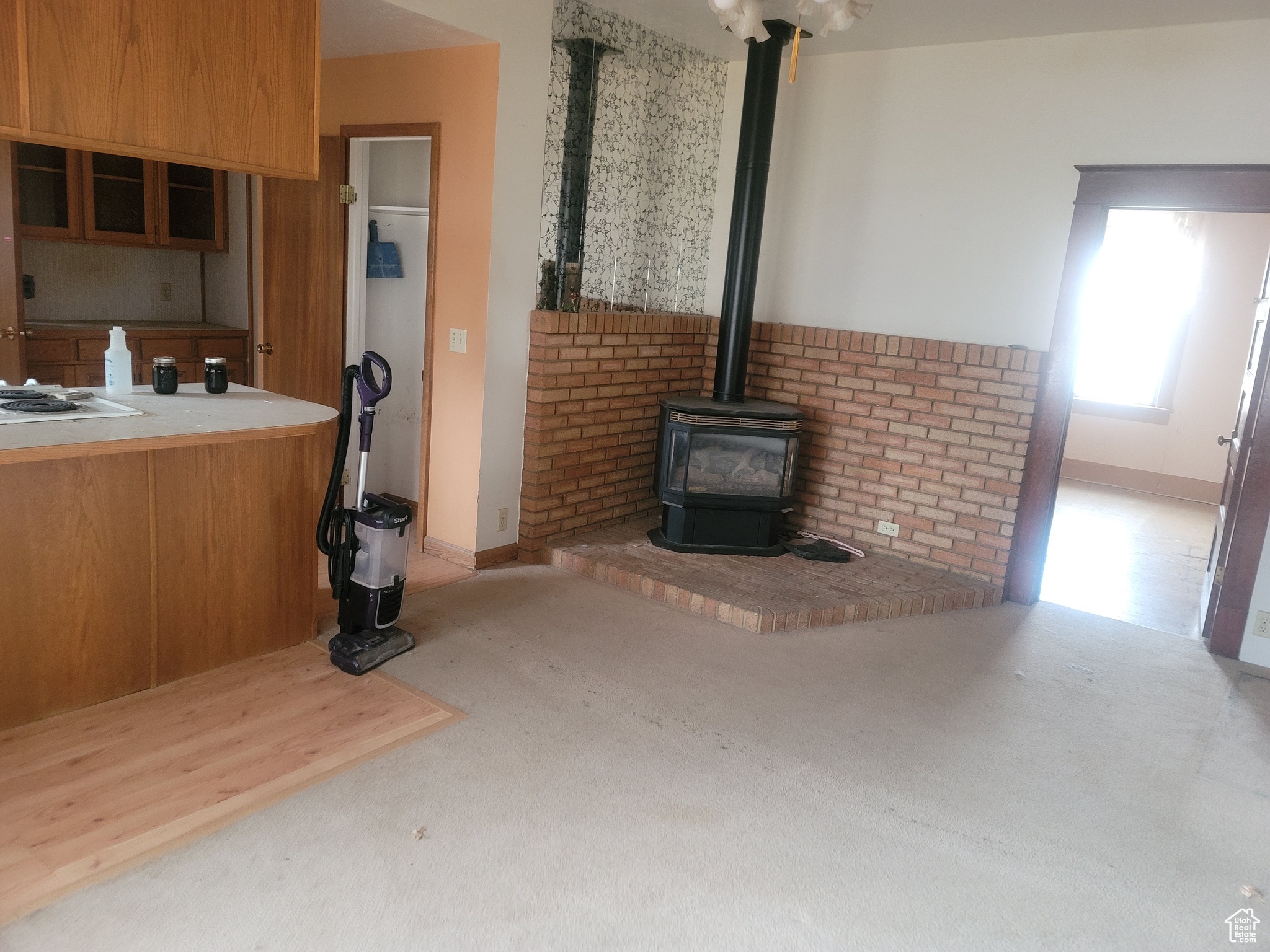 Unfurnished living room with a wood stove