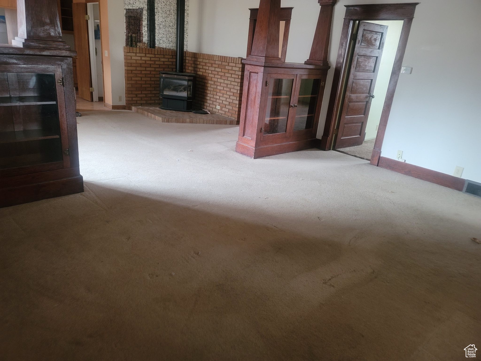 Unfurnished living room with a wood stove